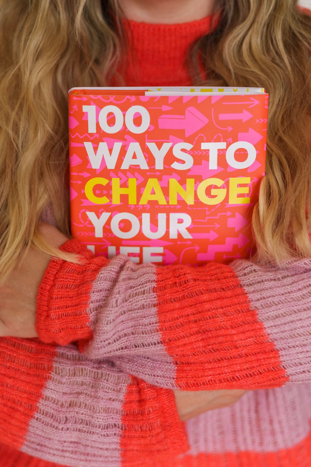Book cover design showing text in red and pink colors with decorative patterns.