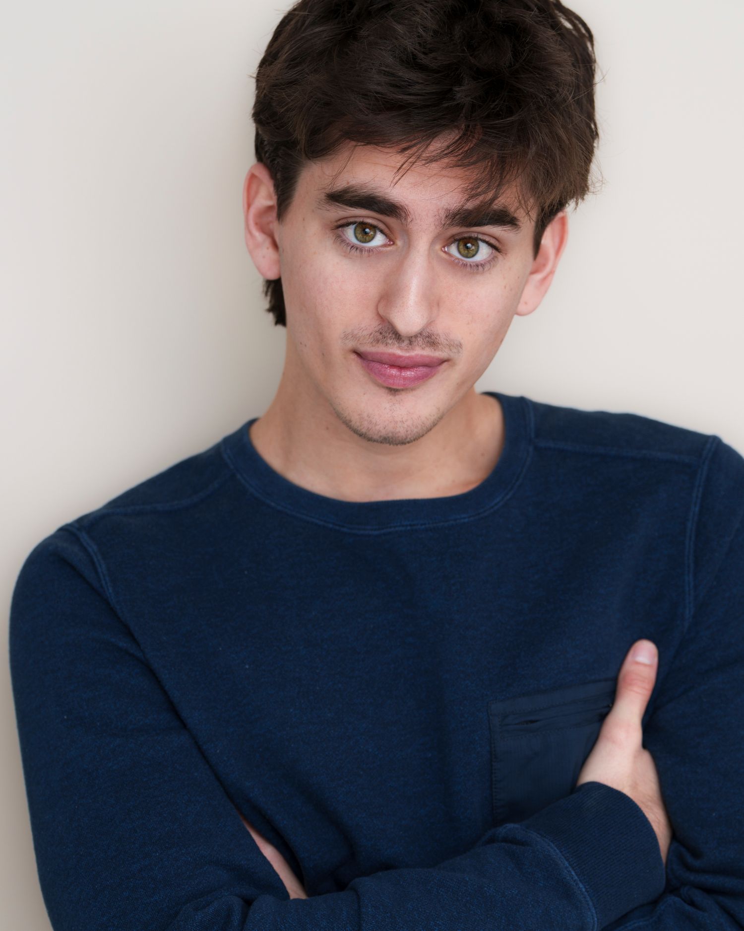 Headshot series showing different poses in a navy blue sweater.