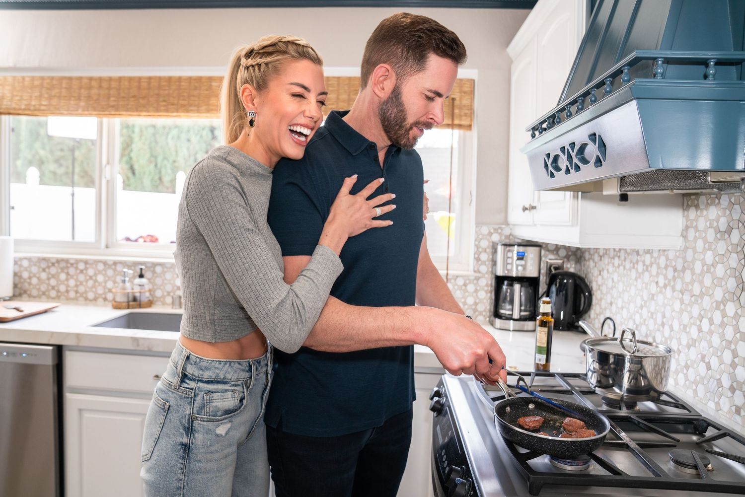 Tarek El Moussa and Heather Rae El Moussa cooking in the kitchen, shot by Los Angeles Photographer Lindy Lin