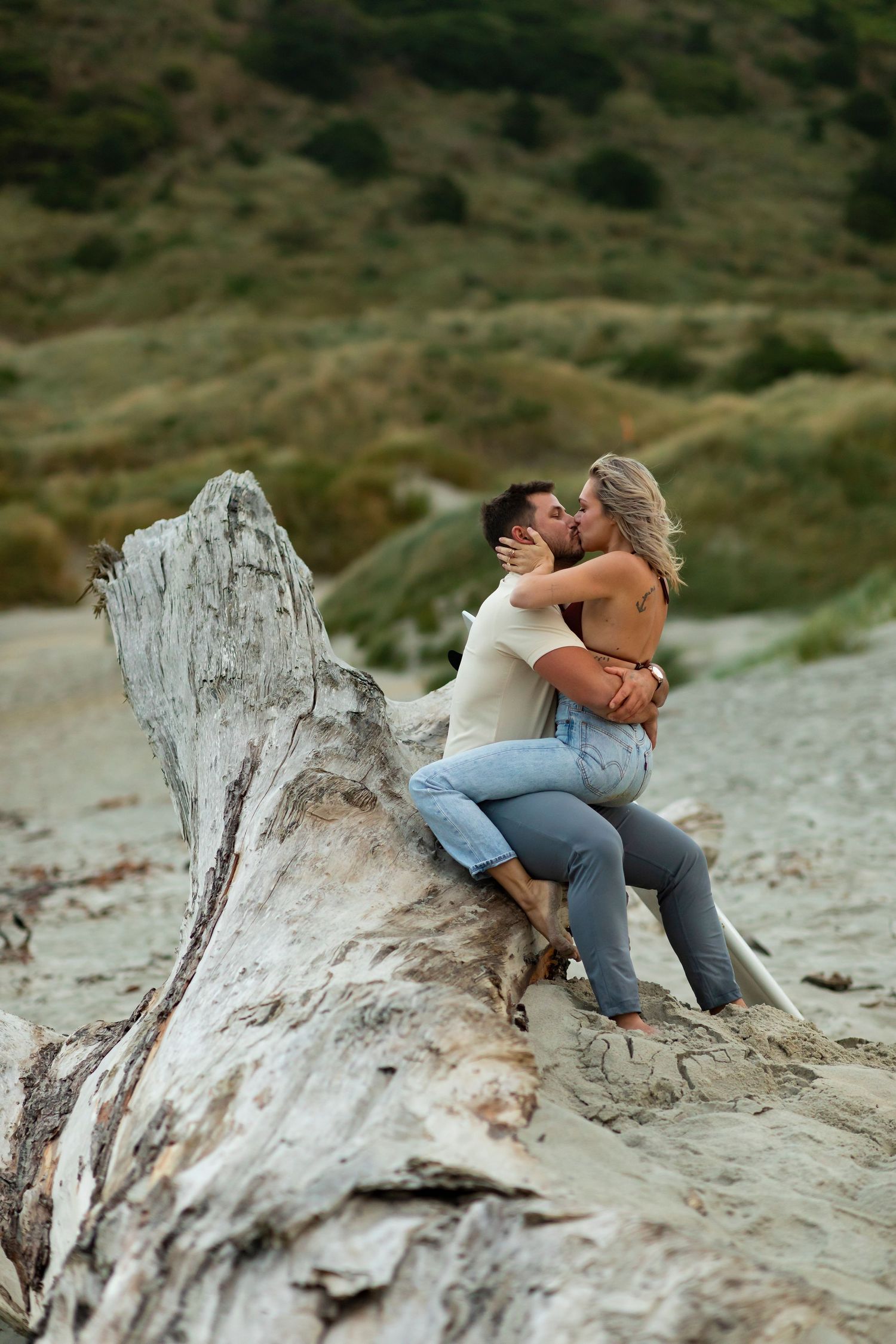 destination photoshoot of beach engagement new zealand couple steamy make out sesh