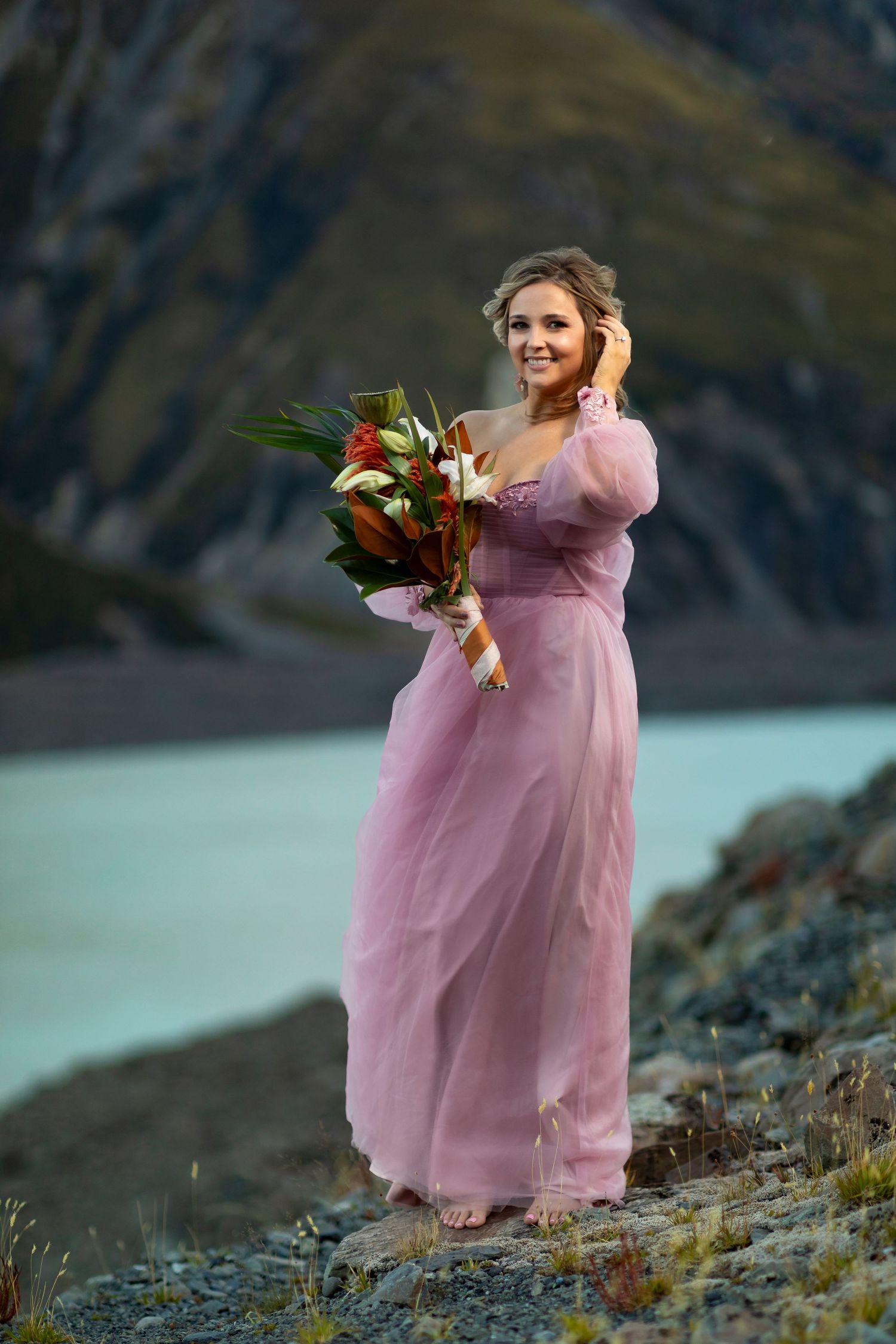 mountain top destination vacation photo of woman in pink dress