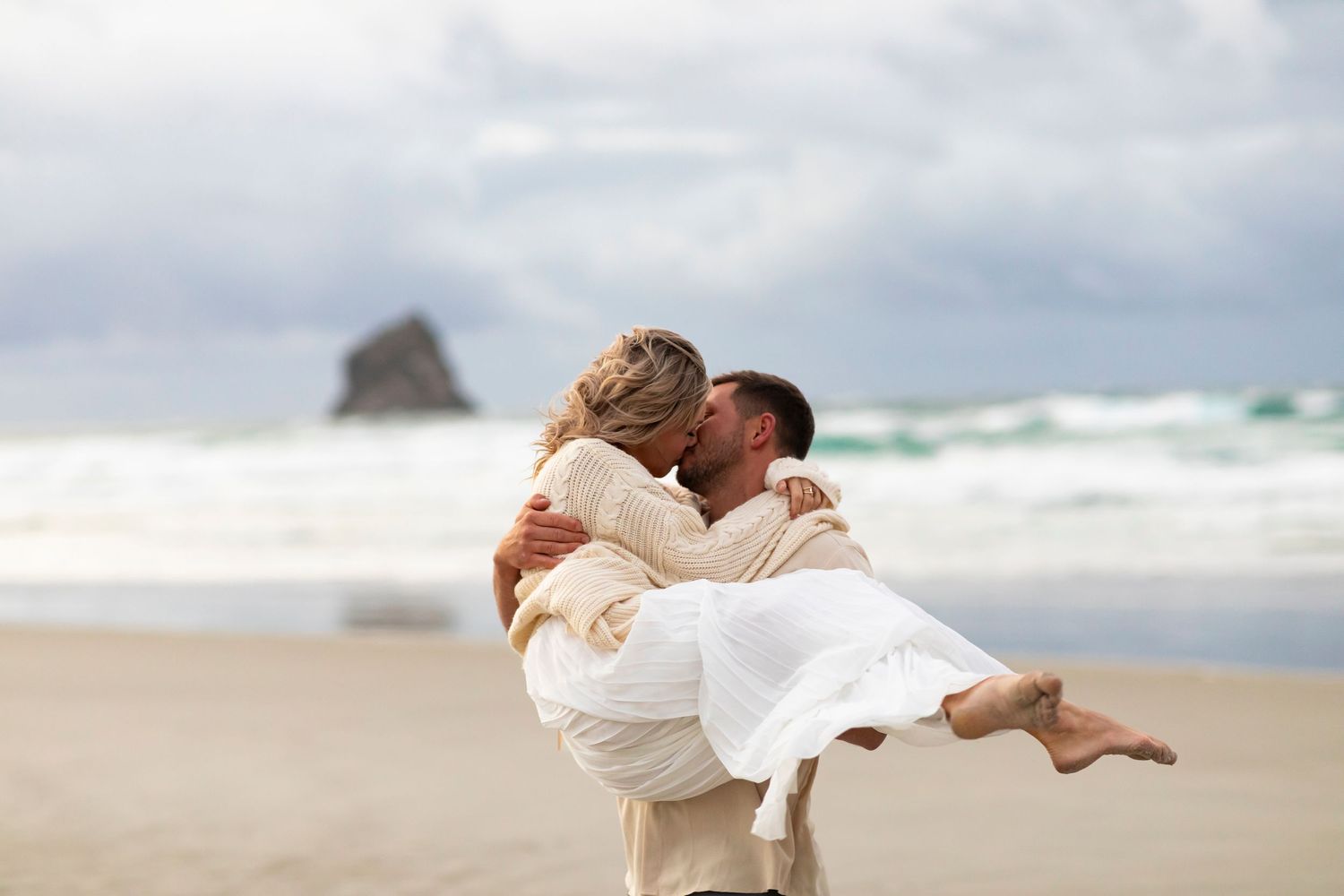 vacation photo of couple on beach in New Zealand holding her