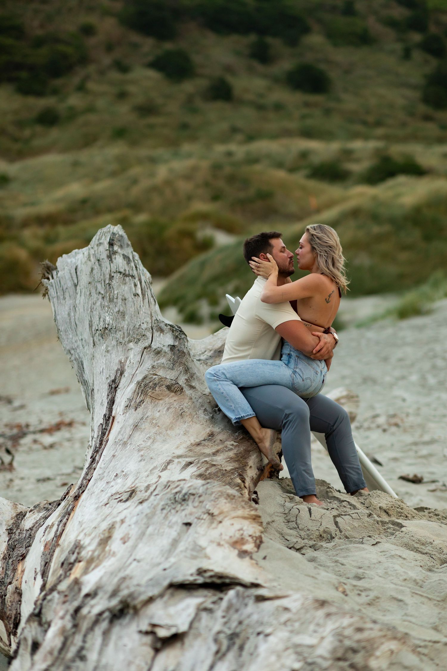 destination photoshoot of beach engagement new zealand couple steamy make out sesh