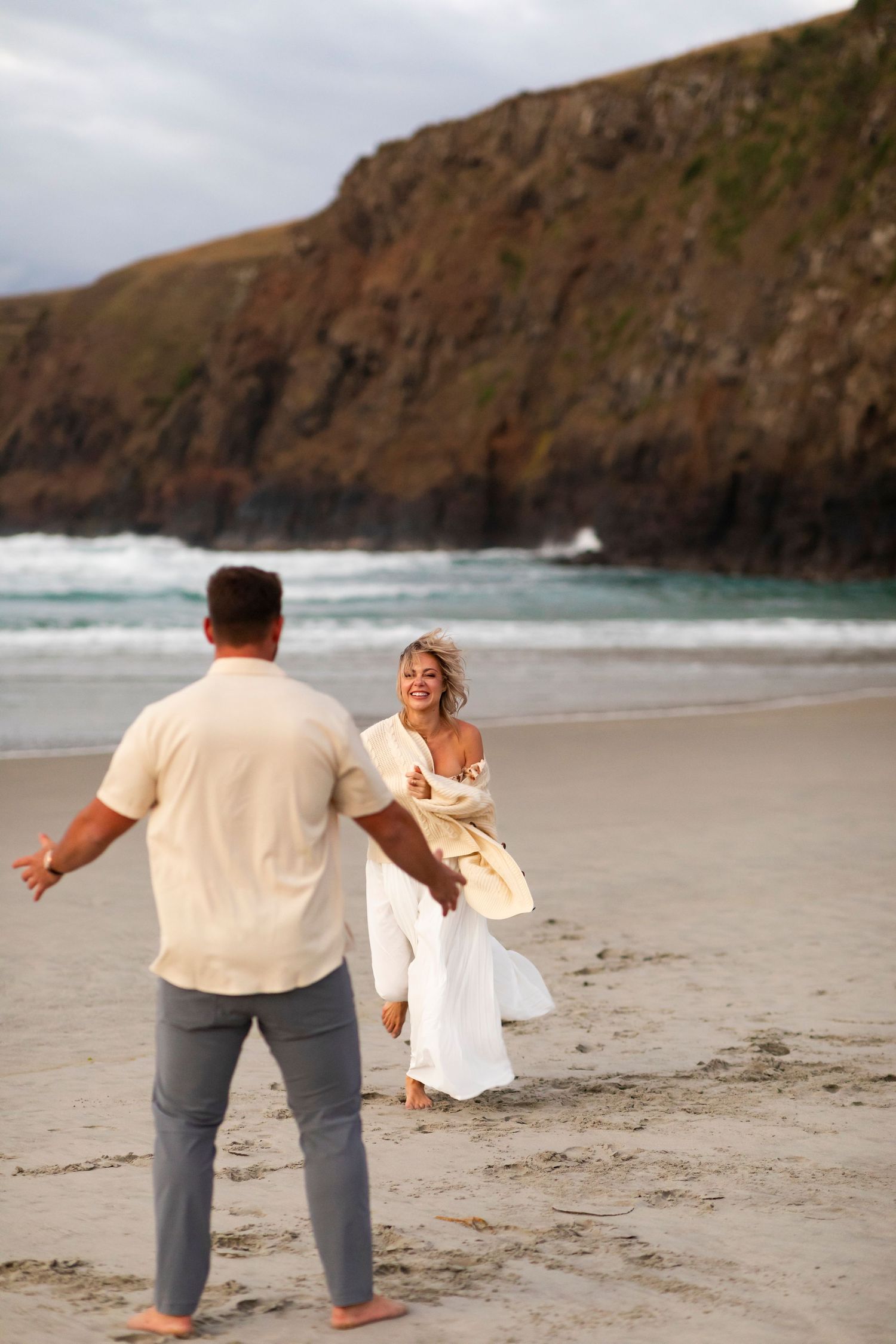 destination photo of couple on beach in New Zealand