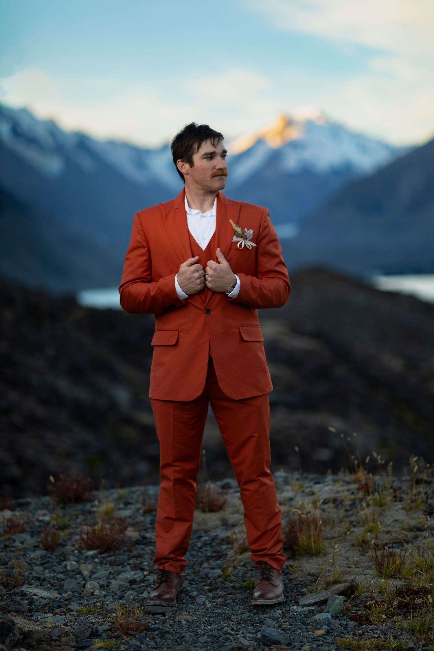 mountain top destination photography man in orange suit
