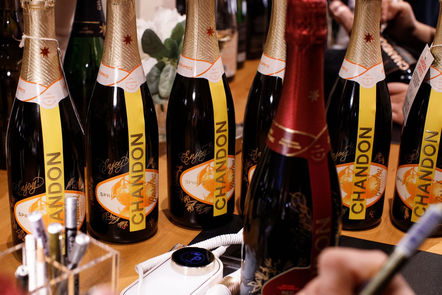 Multiple Chandon sparkling wine bottles displayed in a row at a festive event or tasting.