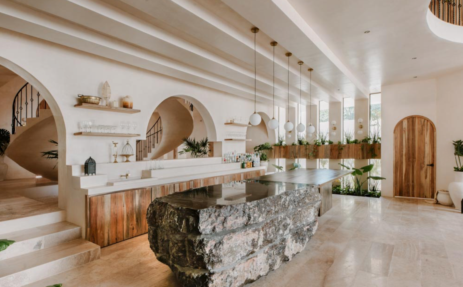 Modern interior design featuring arched doorways, marble counters, and warm wood accents in a minimalist open space.