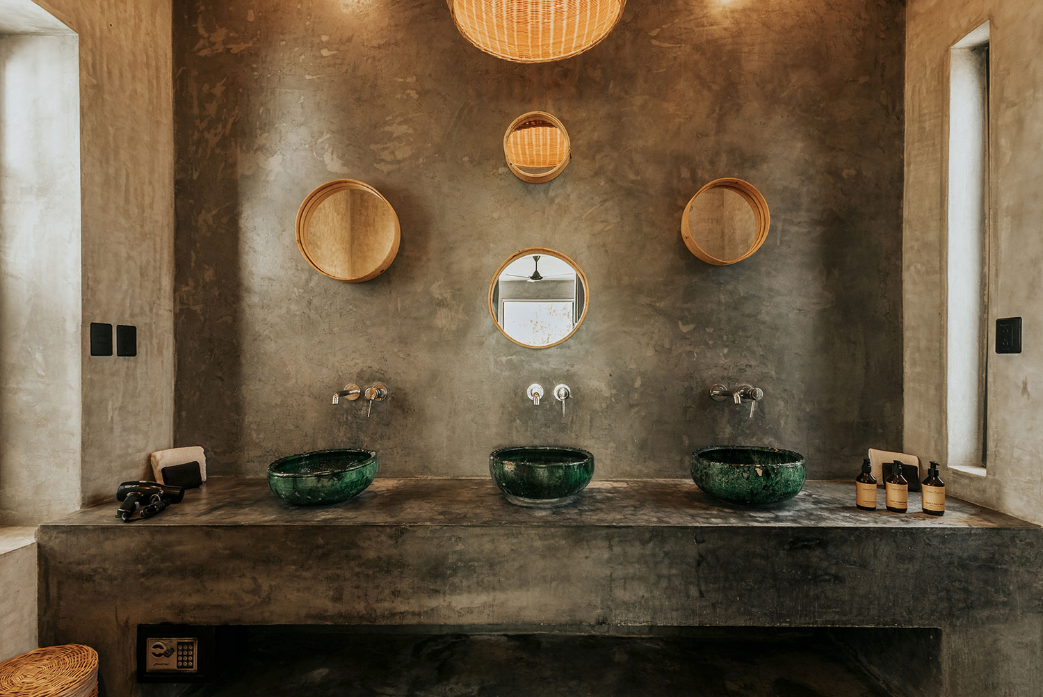 Modern restaurant interior with hanging paper lanterns and textural concrete walls creating a minimalist atmosphere.