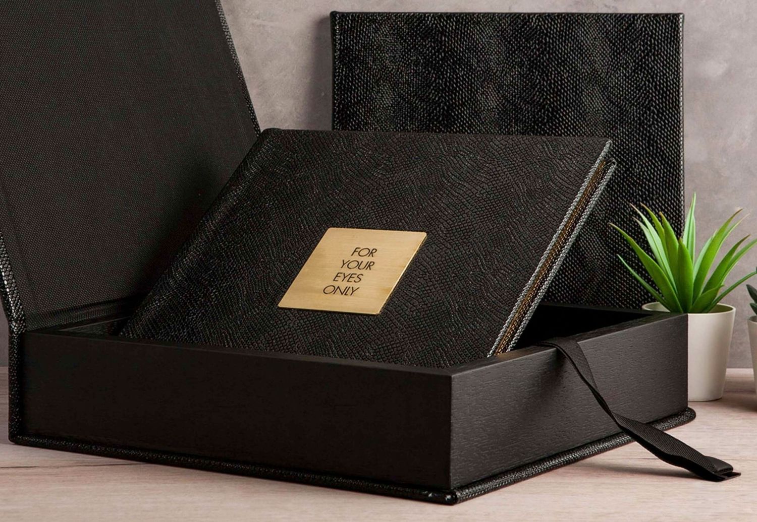 Bridal boudoir photography New Orleans - Elegant black leather photo album with gold embossed text, presented in a luxury magnetic gift box.