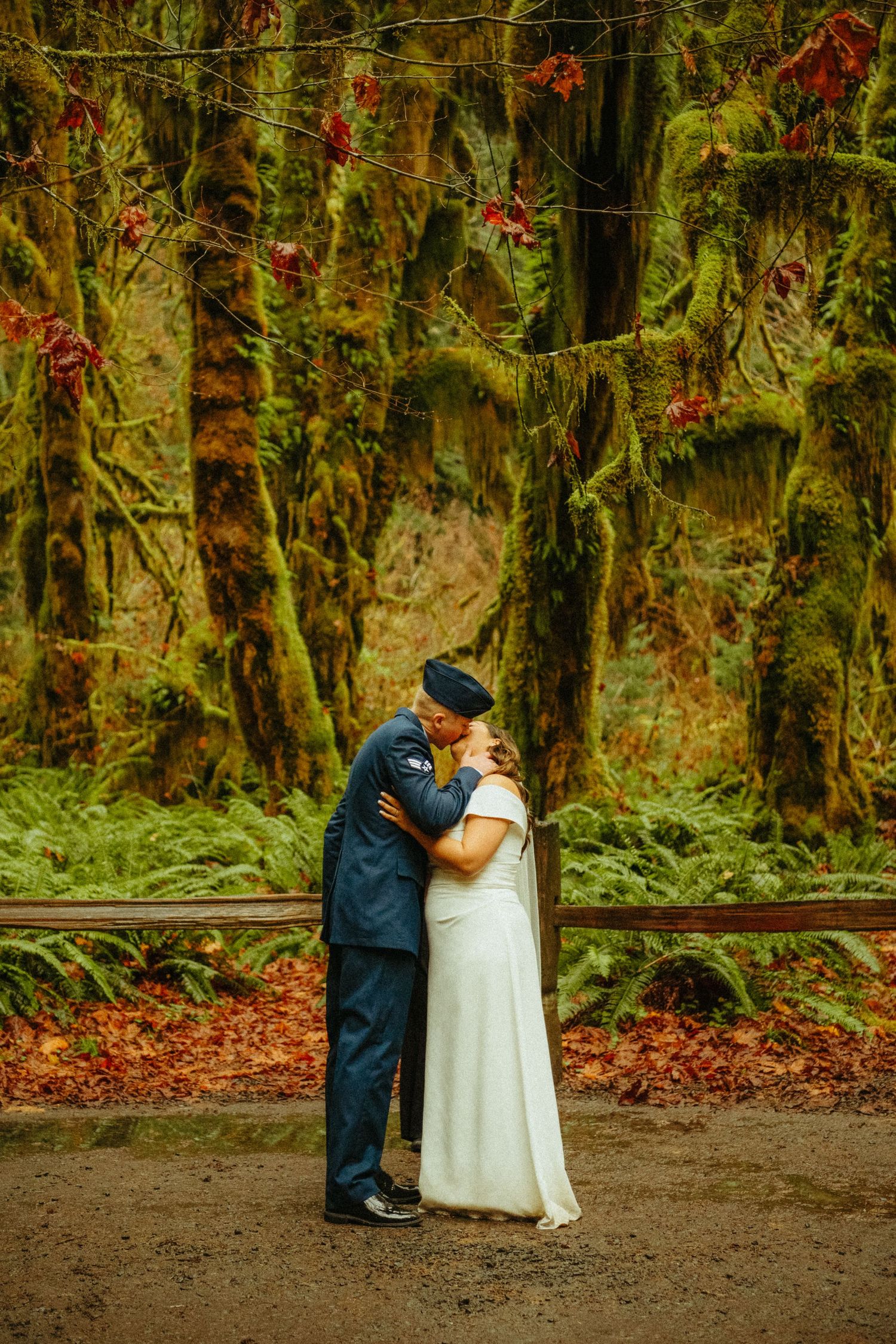 A romantic moment captured in a mossy Pacific Northwest forest with autumn colors and beautiful natural scenery.