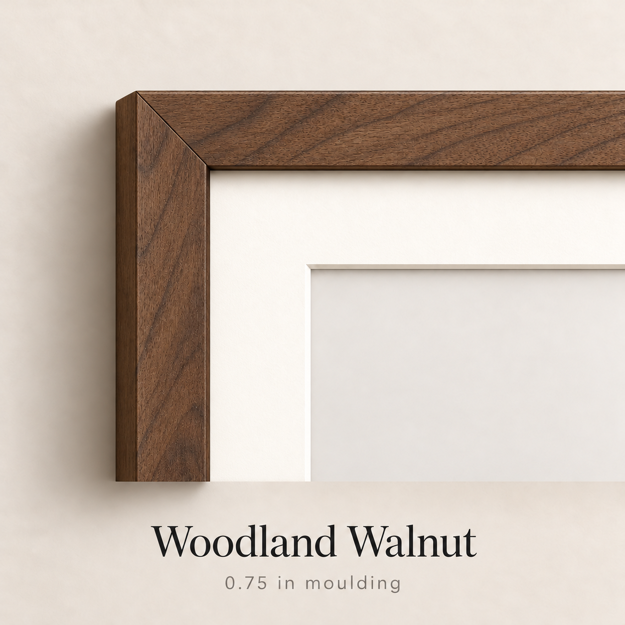 Close-up of a Woodland Walnut picture frame corner with 0.75 inch moulding and a white mat, shown on a neutral wall.