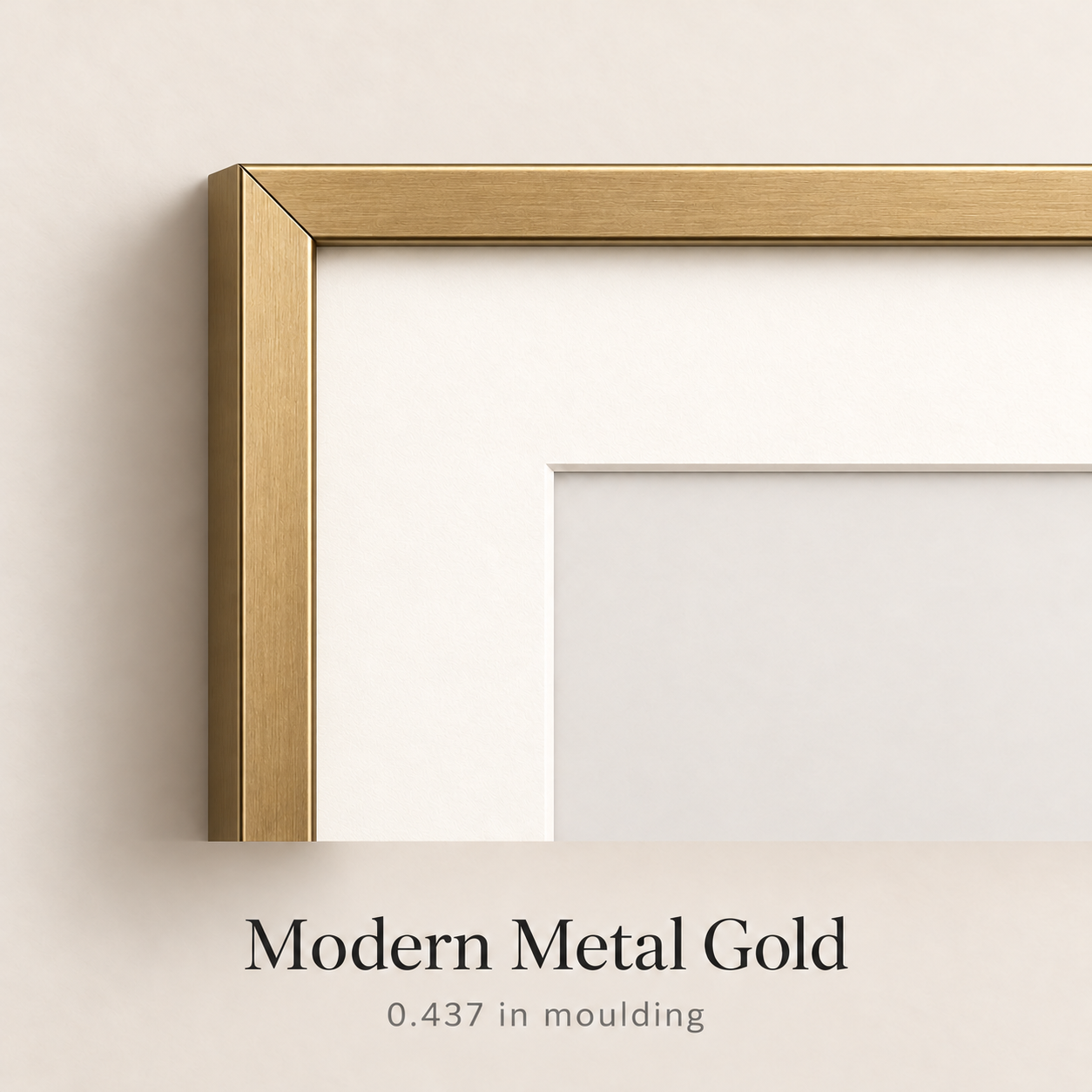 Close-up of a modern metal gold picture frame corner with a white mat, labeled 0.437 in moulding.