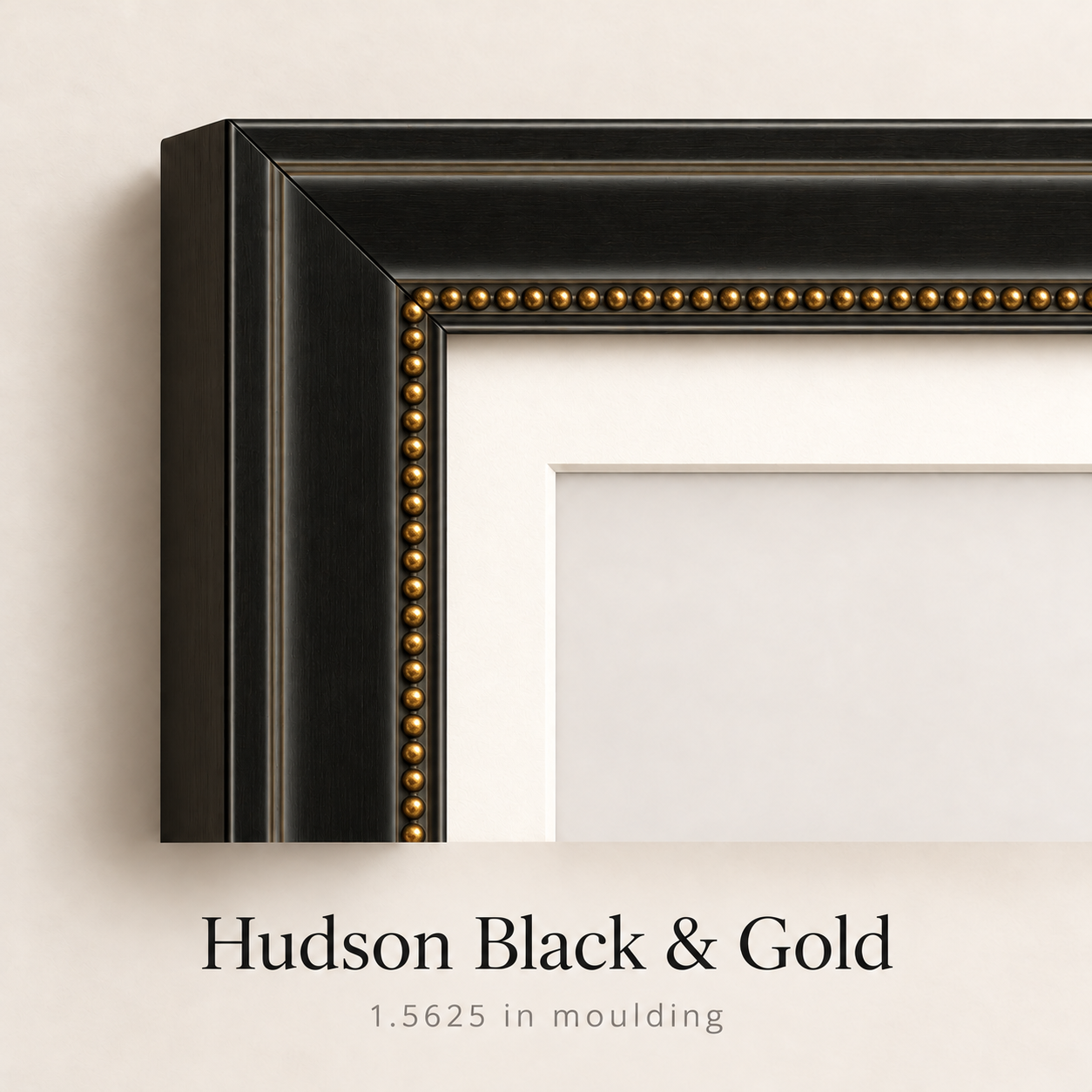 Close-up corner of the Hudson Black & Gold picture frame with 1.5625 inch moulding, gold beaded inner edge, and white mat.
