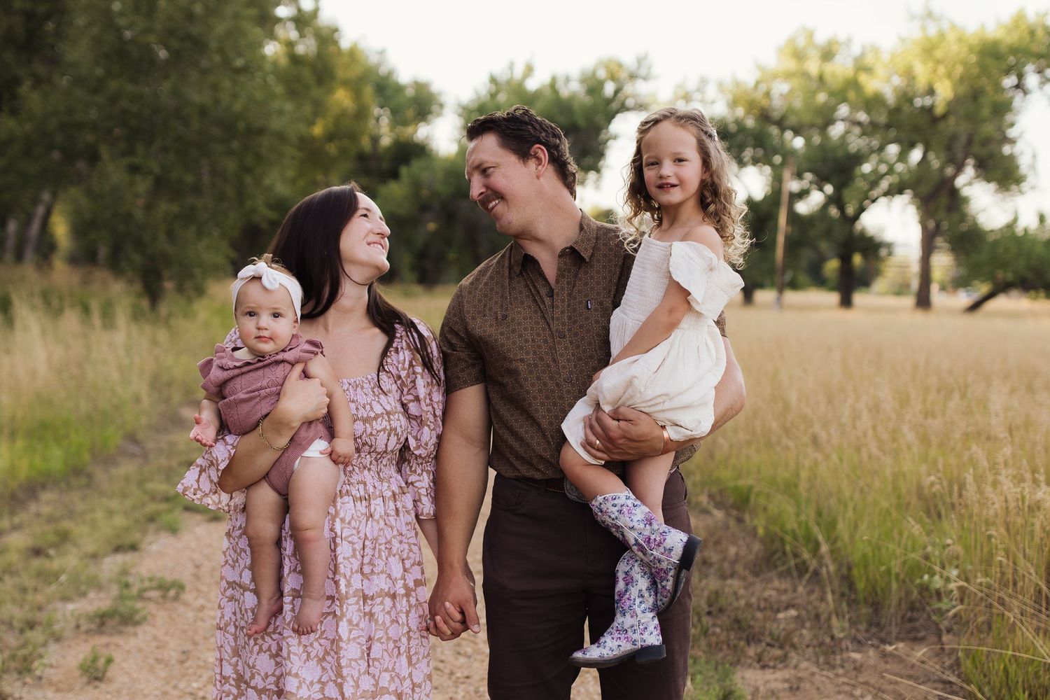 A series of outdoor family photographs captured in a sunlit grassy field at golden hour.