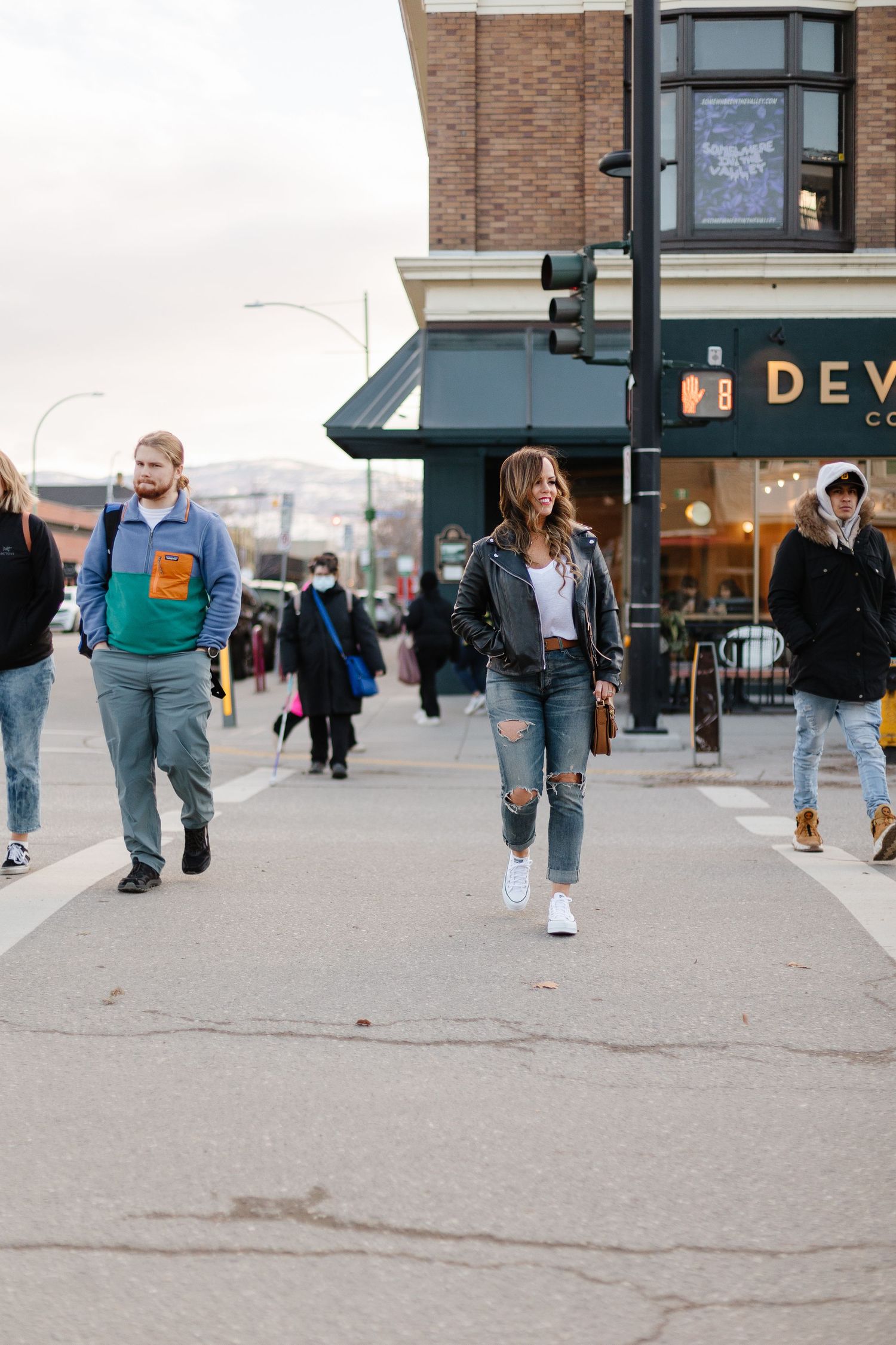 A series of five cropped photos showing legs and feet of people walking on a concrete sidewalk in casual attire.