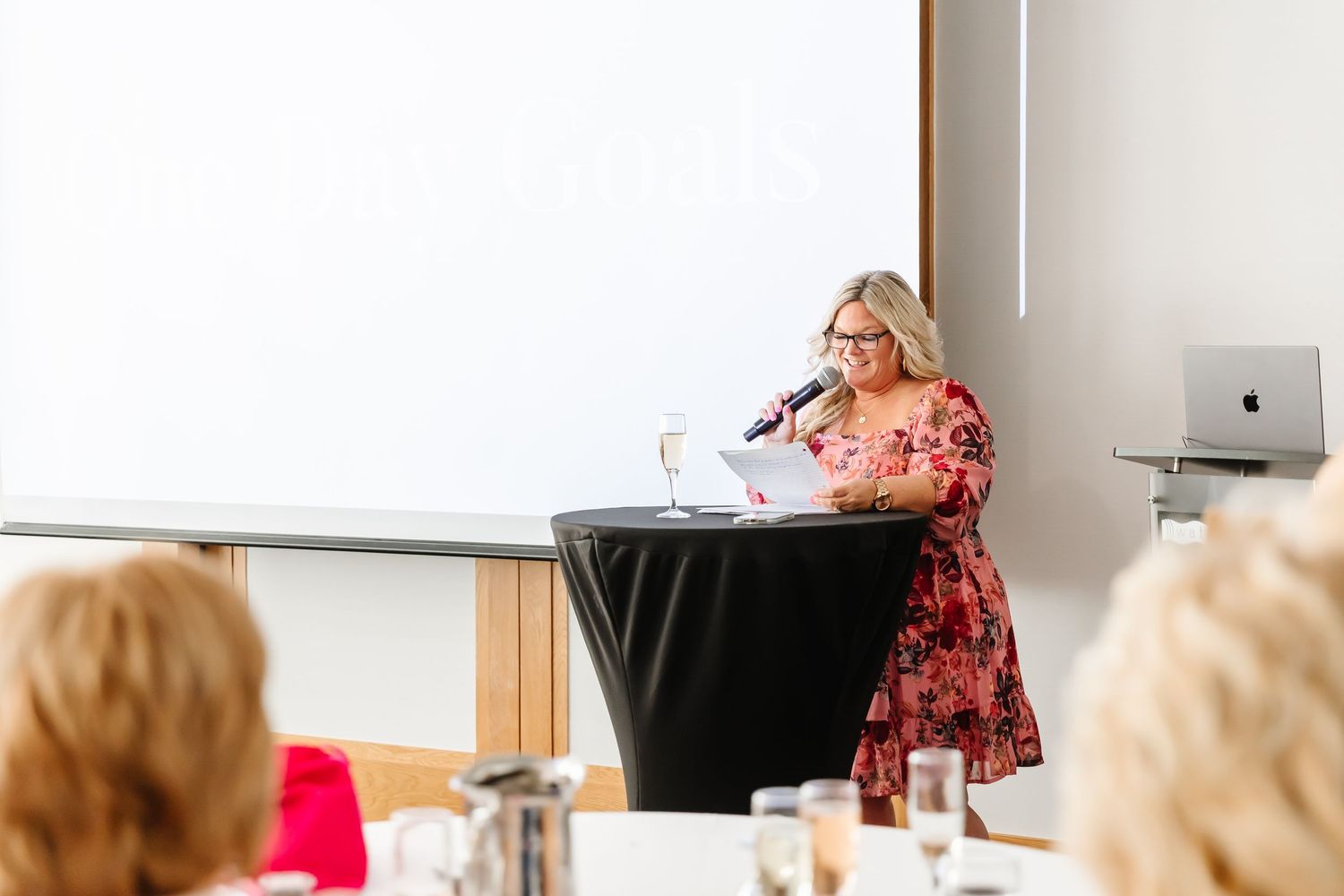 Candid photo of Susie Helland speaking at the Build your brave women's retreat located in the Okanagan at the Watermark Resort