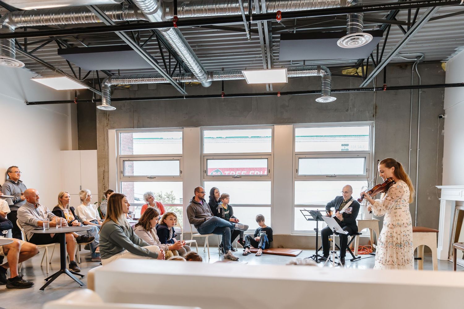 A panoramic view of people sitting in chairs during a business meeting in a modern office space.