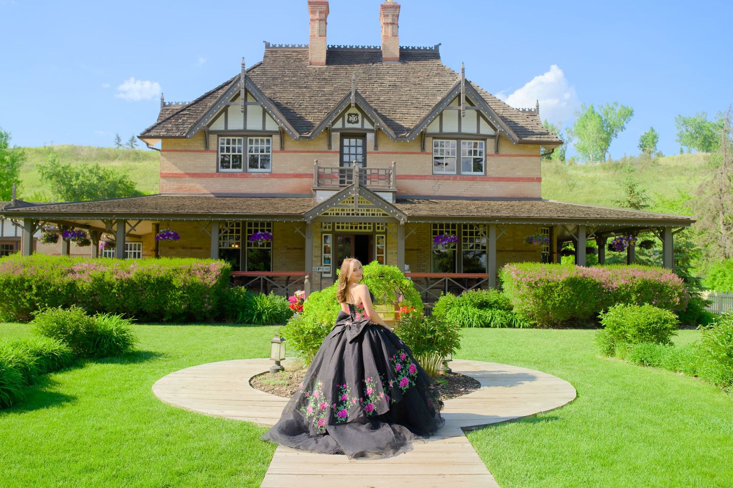 A series of historic homes and landscaped gardens along a path showcasing residential architecture and outdoor amenities.