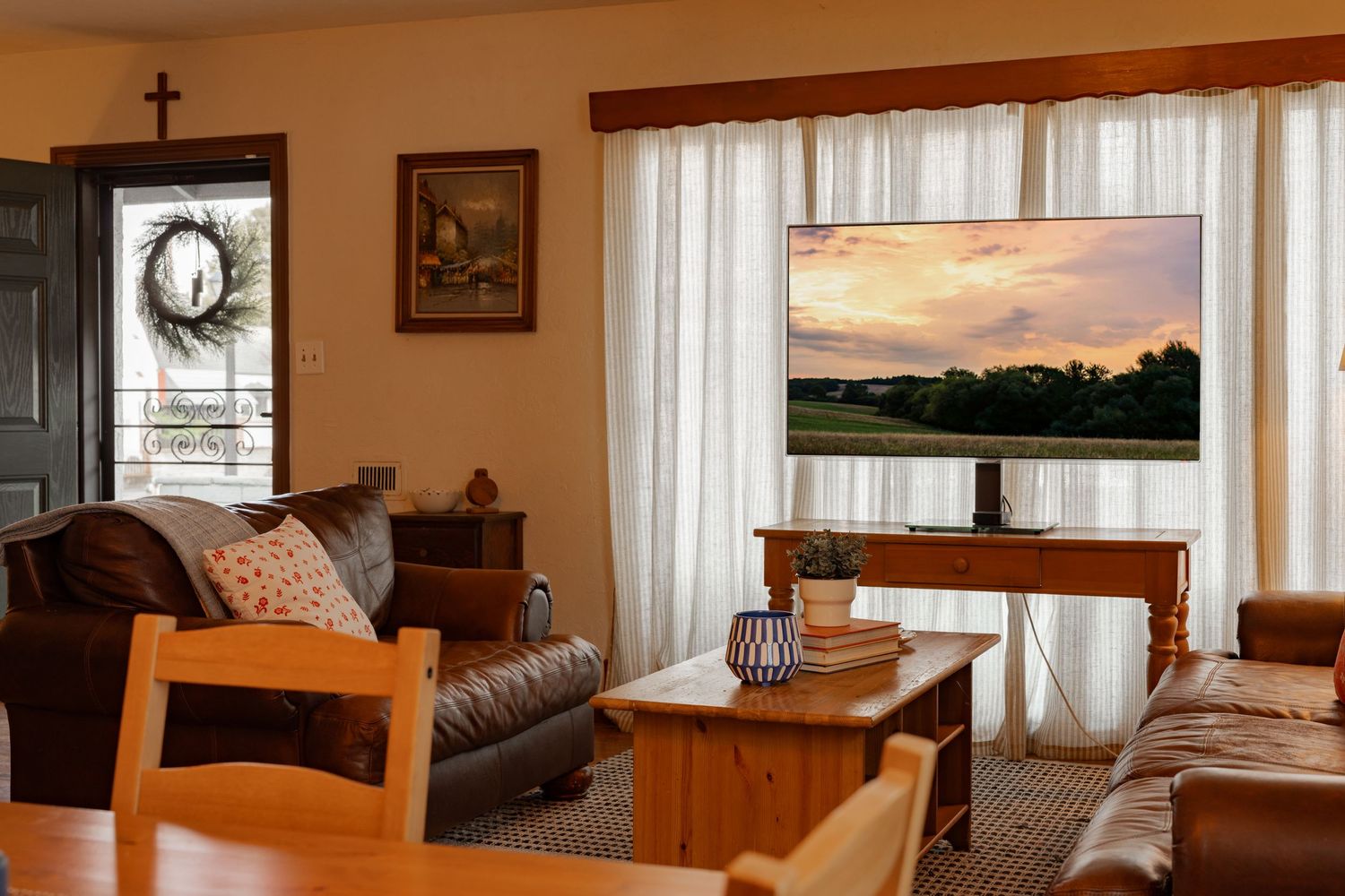 Cozy rustic cabin interior with wooden furniture, leather sofa, and warm lighting showcases a comfortable living space.