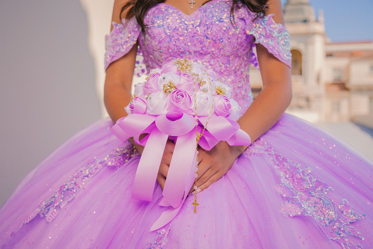 A lavender purple quinceañera dress with floral embellishments and a full tulle skirt sparkles in multiple views.