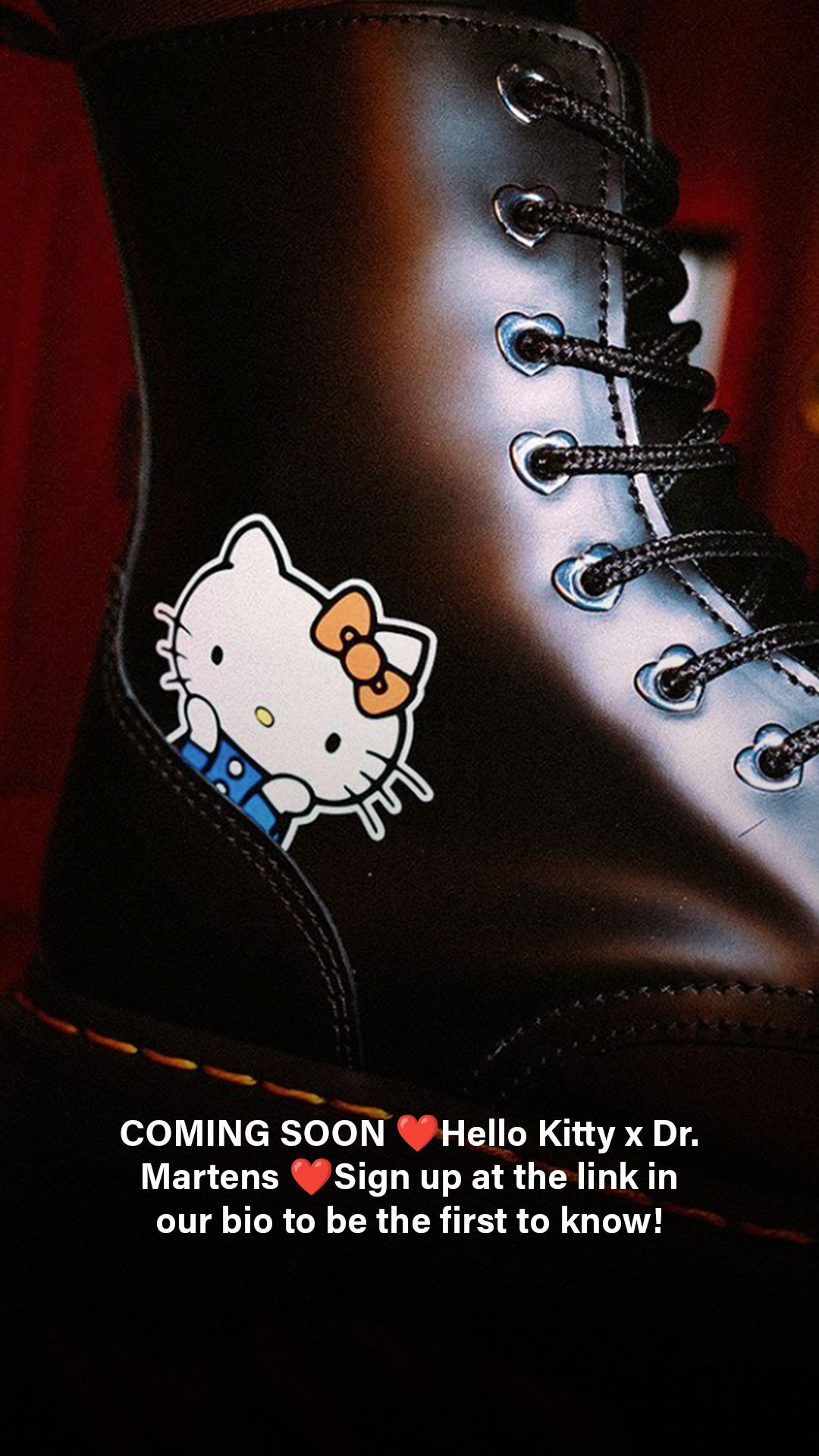 Close-up teaser image of black Dr. Martens boots with Hello Kitty character design showing upcoming collaboration.