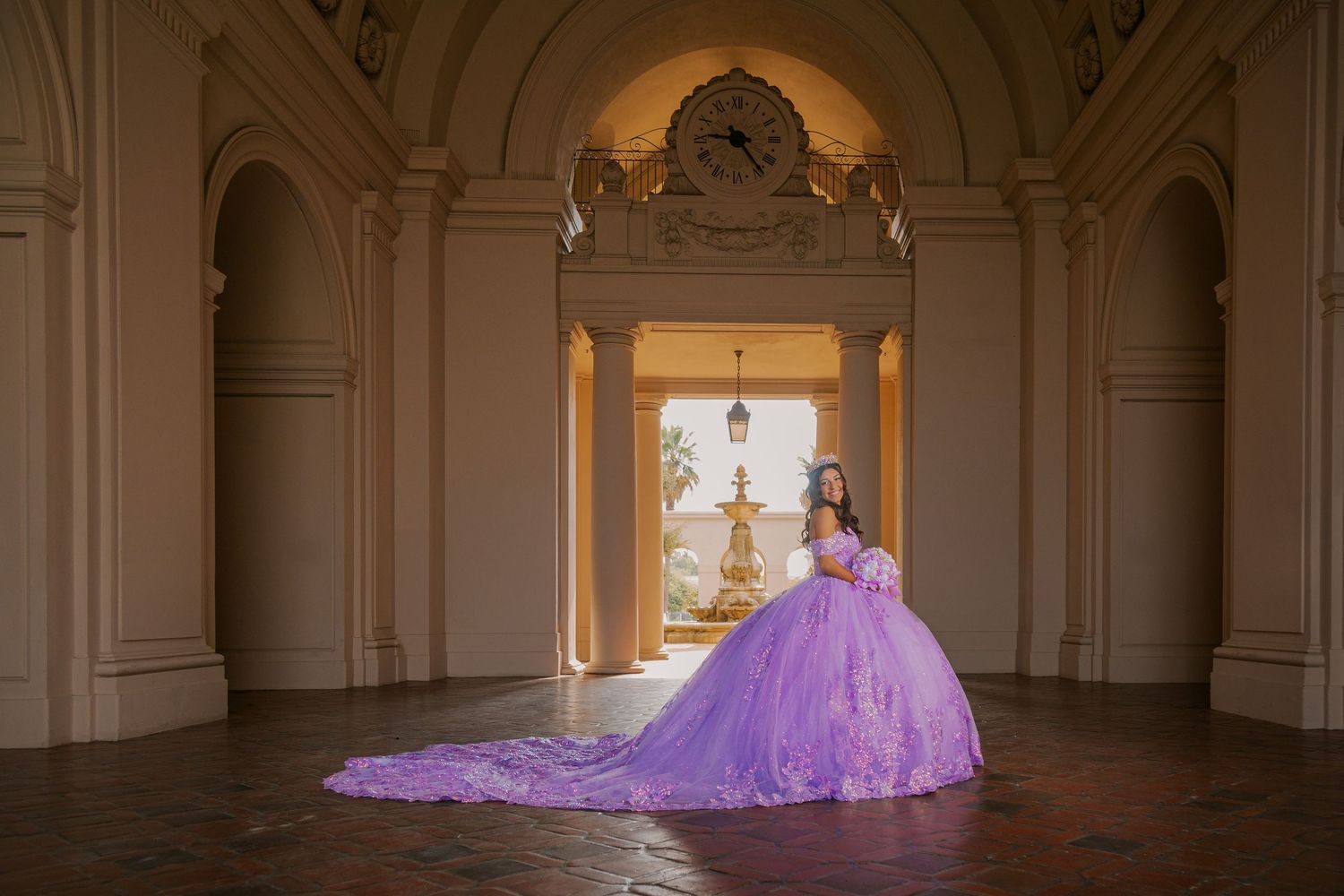 A purple ballgown with a flowing train photographed in sequence across an ornate classical hallway.