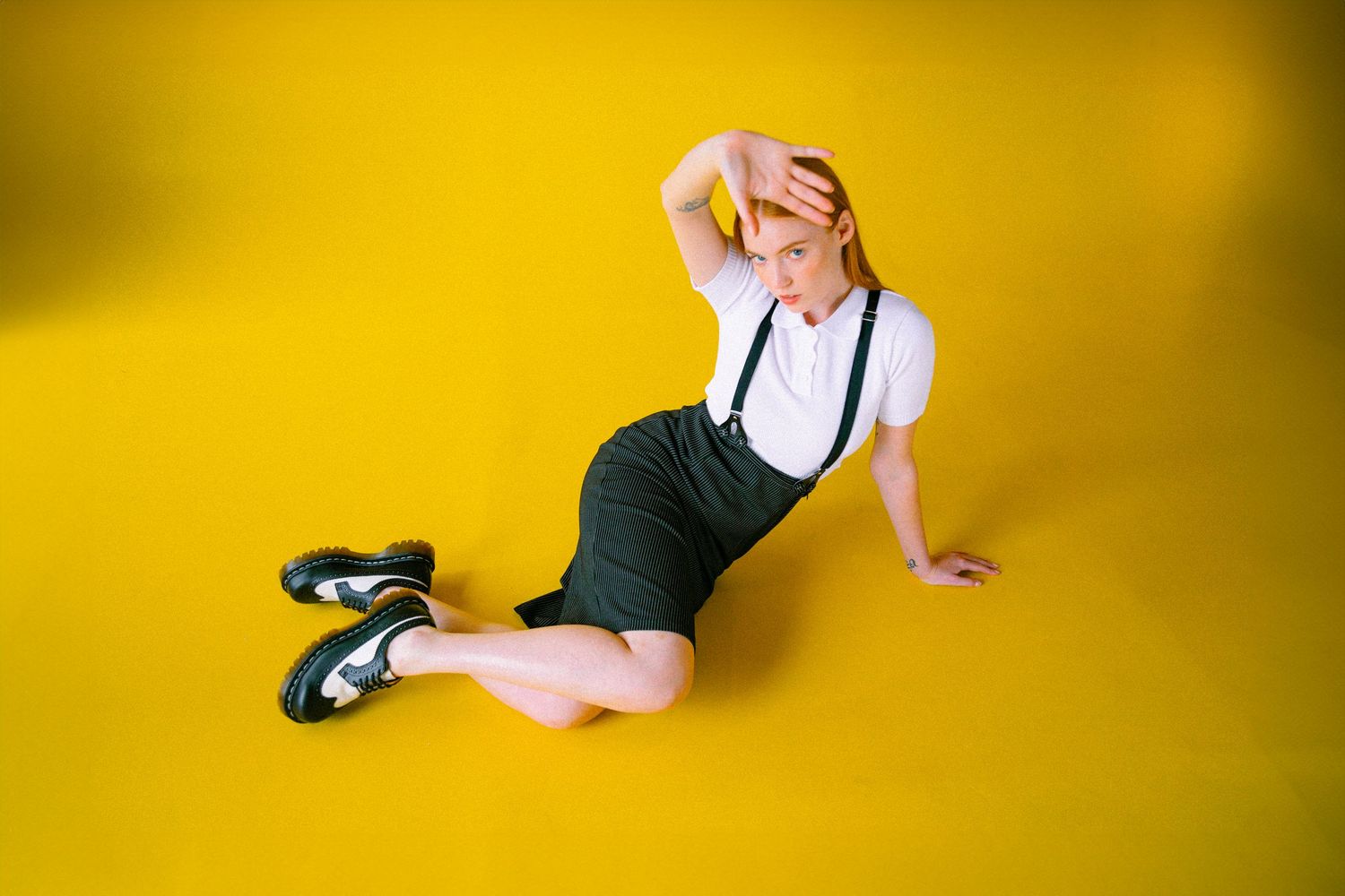 A sequence of dance movements against a bright yellow background shows a person's legs and feet in tap shoes.