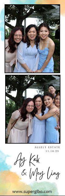 A group wearing light blue and pink dresses poses together at an outdoor wedding celebration at Allely Estate.