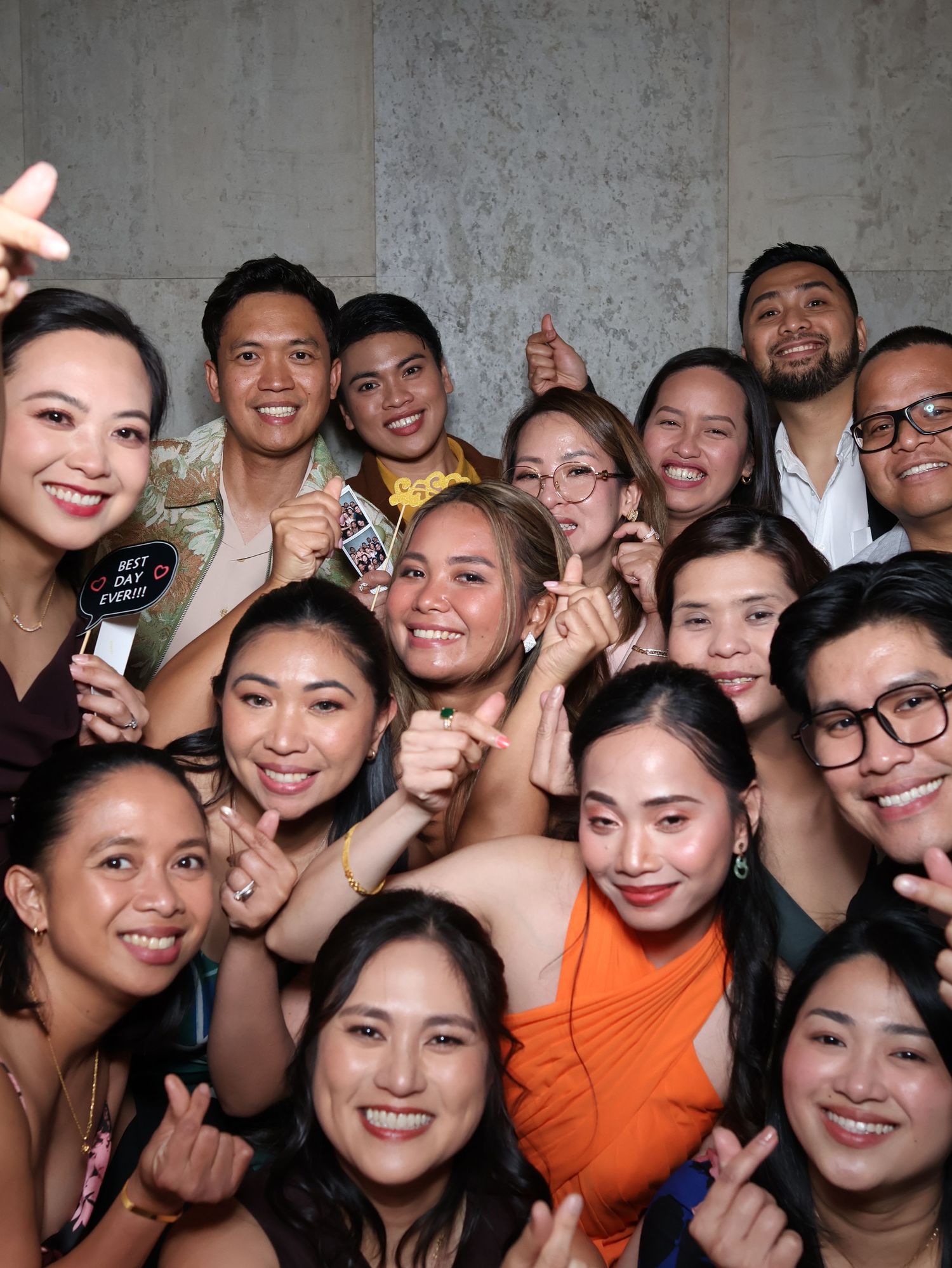 A large group of smiling people posing together in a crowded selfie-style photo.