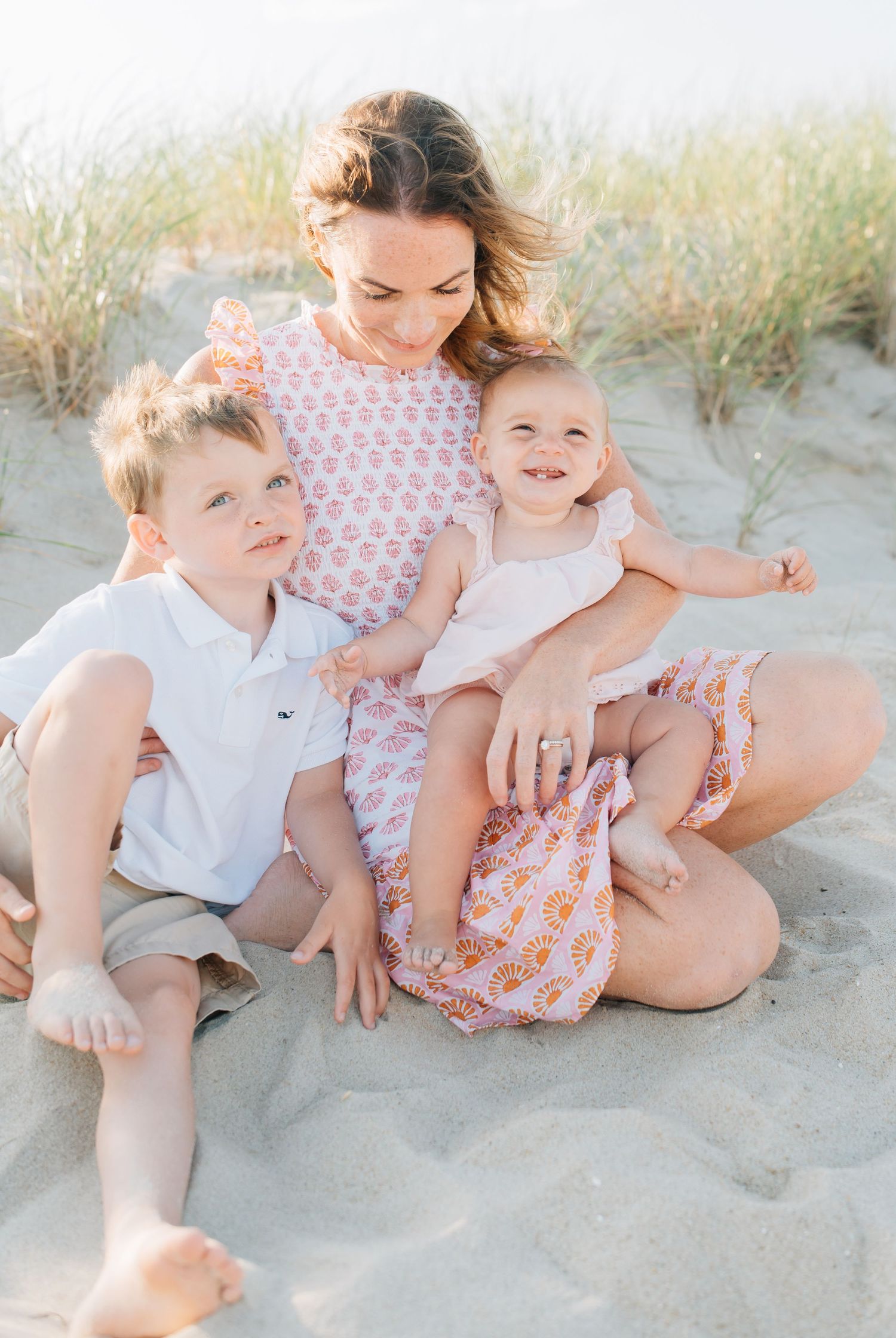 A mother snuggles her children on the beach in Spring lake New jersey.