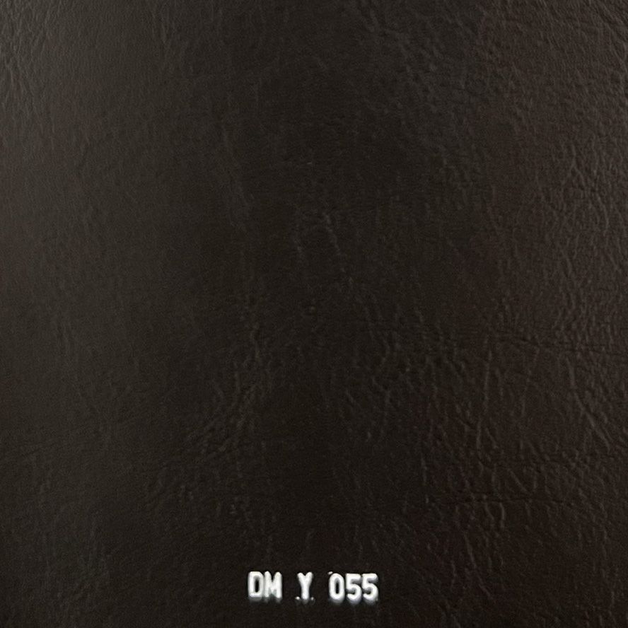 Black leather fabric swatch with subtle grain texture, labeled DM Y 055.