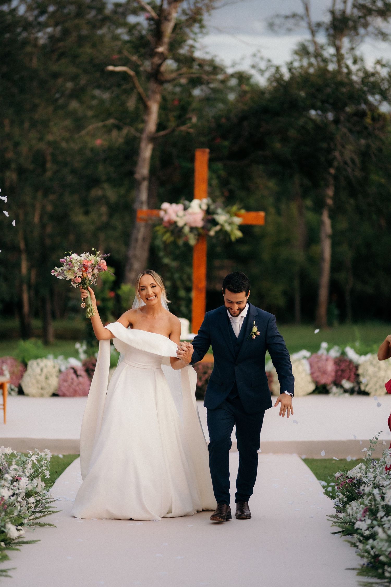 Bride and groom walk down the aisle after their outdoor wedding ceremony.