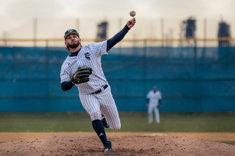 Pinstripe-uniformed pitcher delivers powerful throw during high school baseball game.