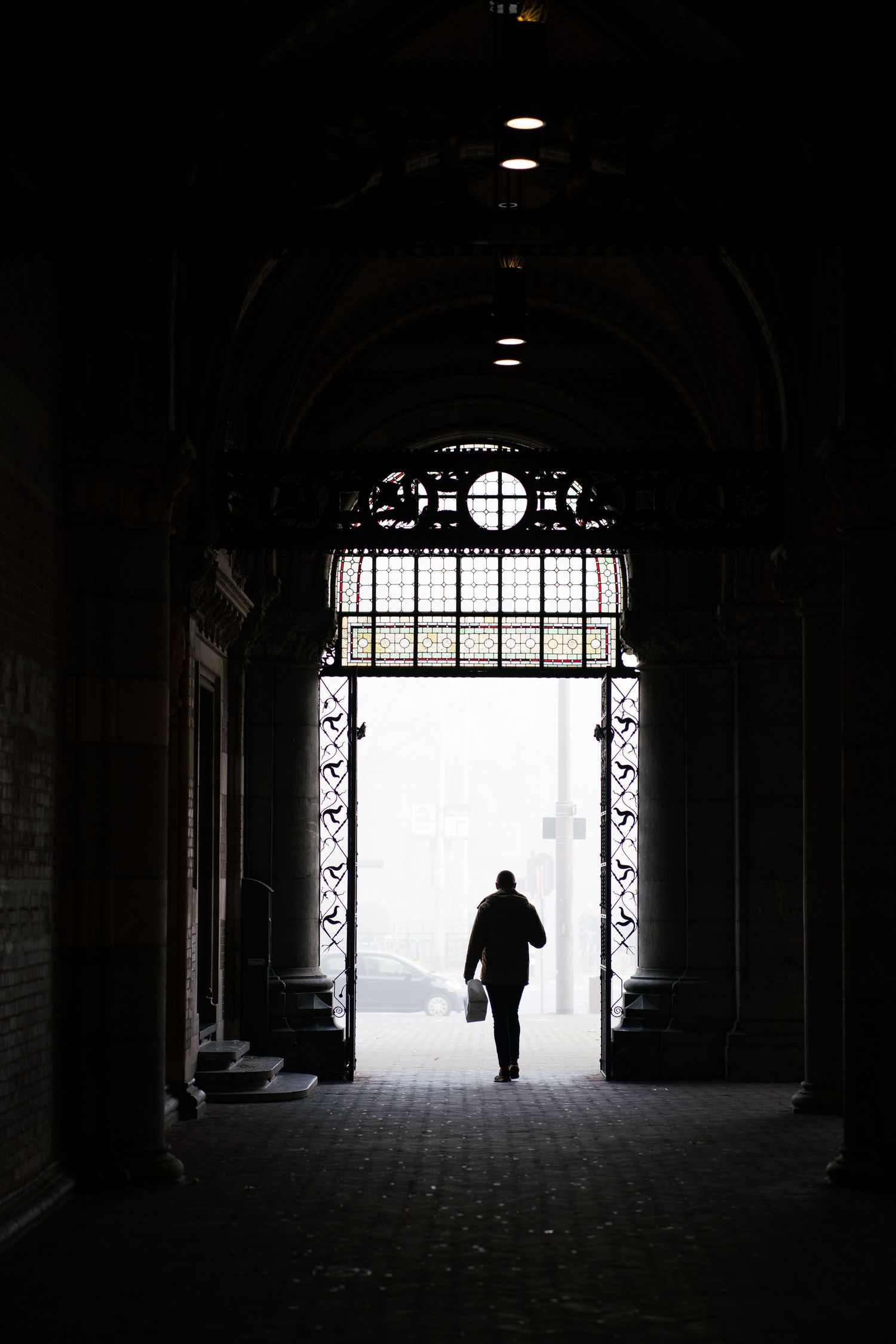 Man walking through archway