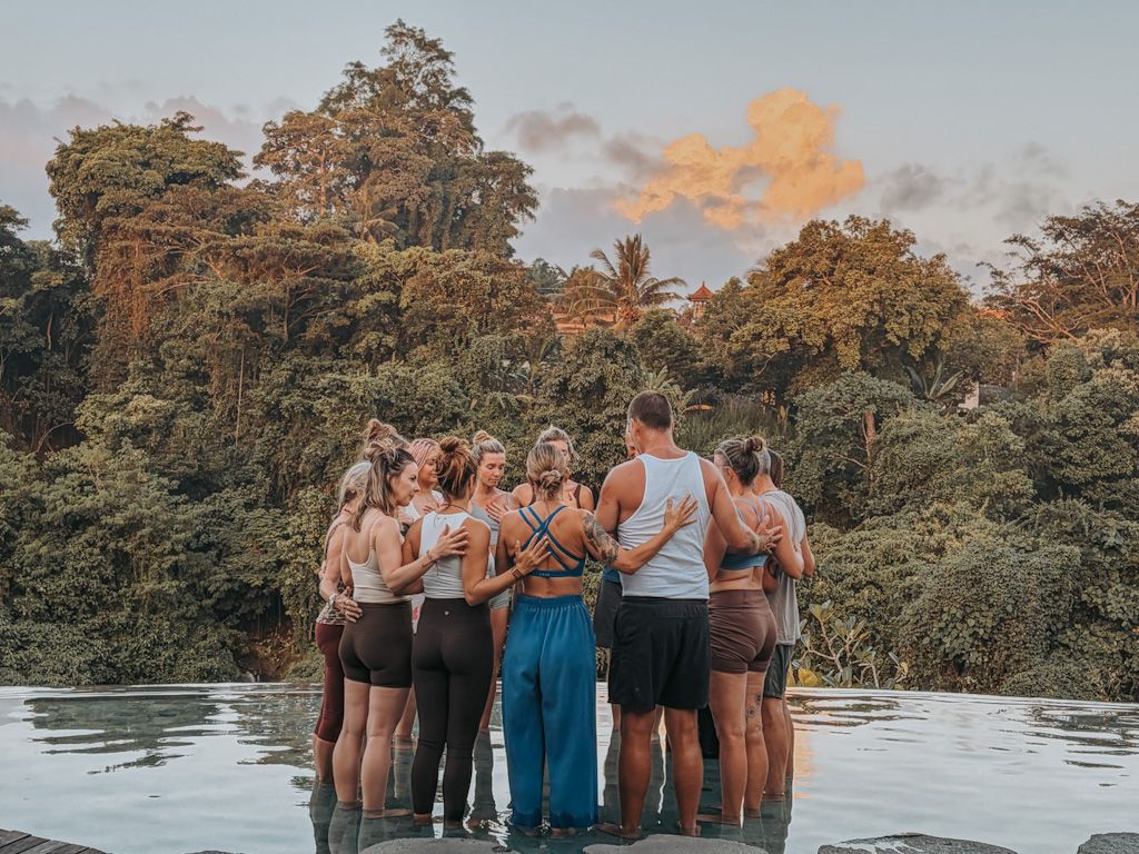 Retreat guests connecting in the pool during a Bali retreat with Ali Mayfield