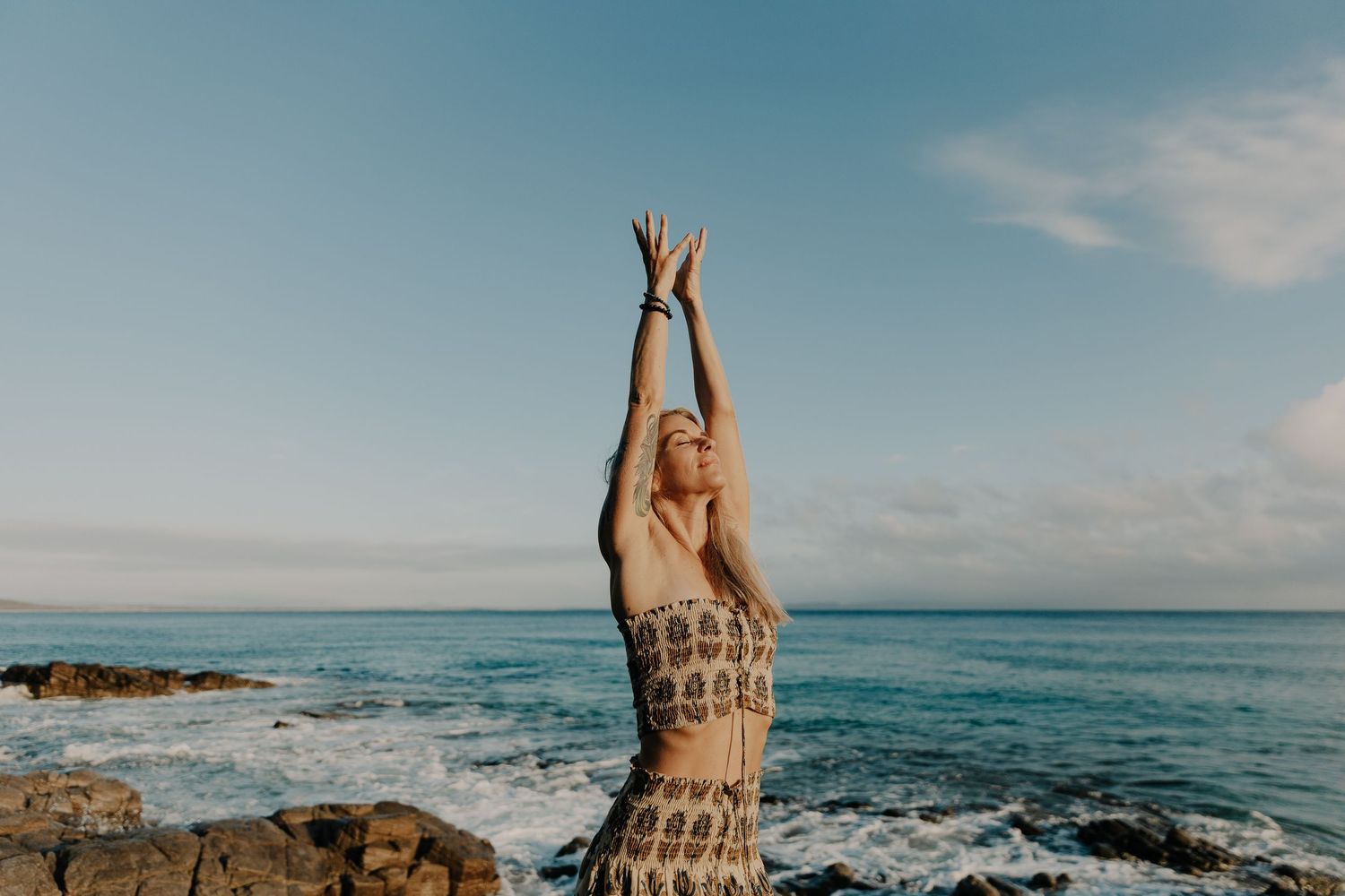 Ali Mayfield standing on the beach on the Sunshine Coast