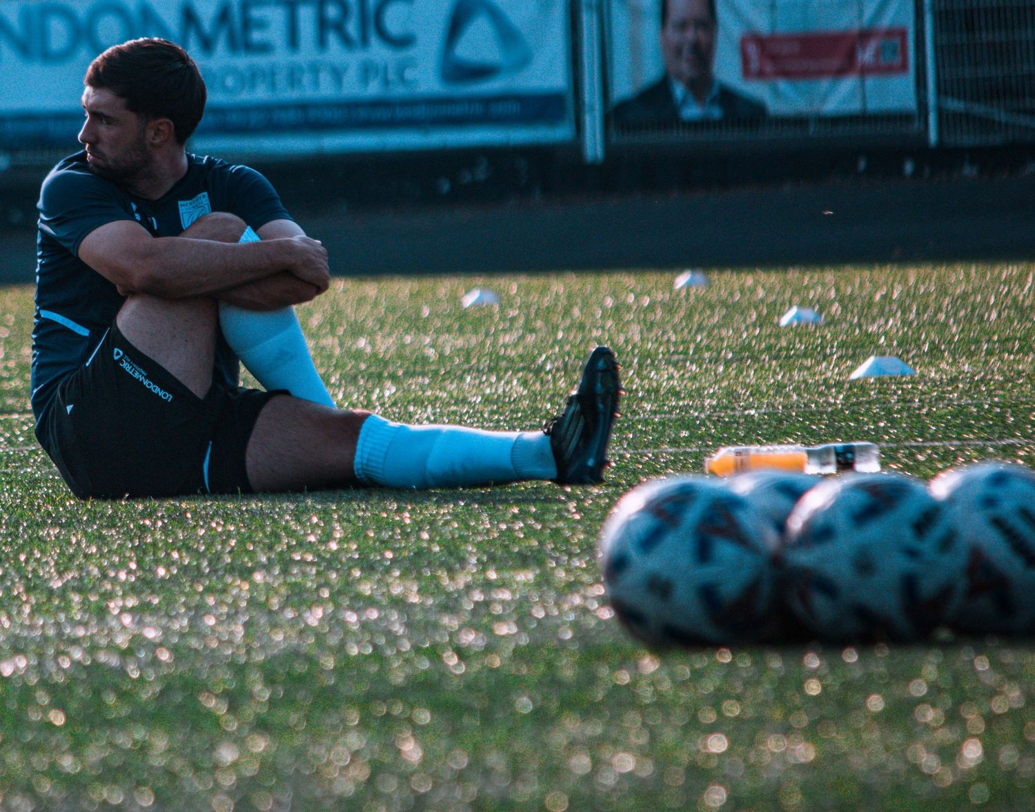Merthyr Town player stretching during a warm up on a matchday