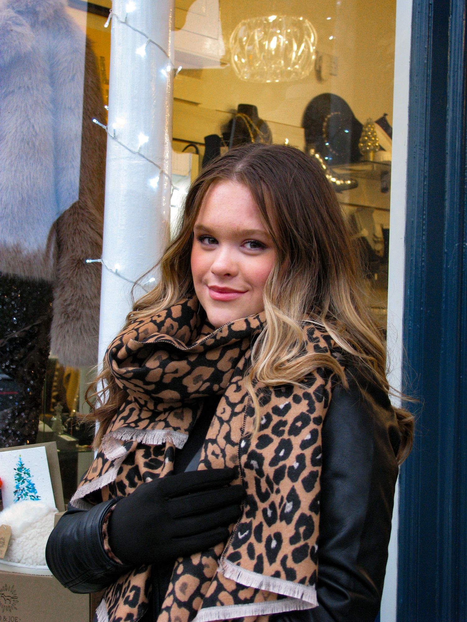 Portrait of a model wearing clothes from Betty’s Boudoir Boutique. Business photography. Leopard print scarf.