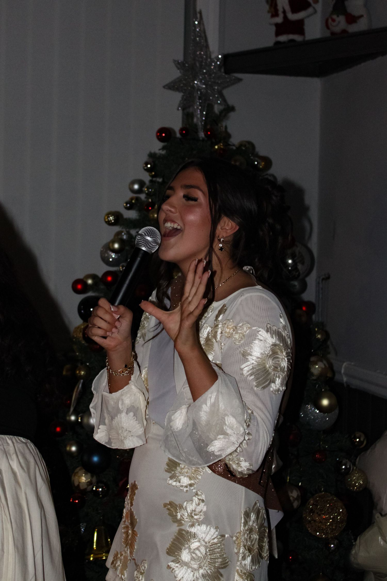 A candid photo of  a woman giving a speech at an 18th Birthday party.