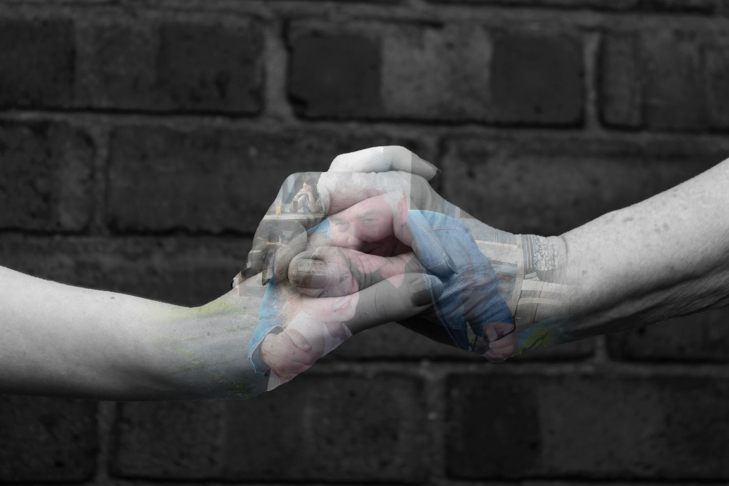 A grandparent and grandchild holding hands. Black and white. A photo of them both is overlayed.