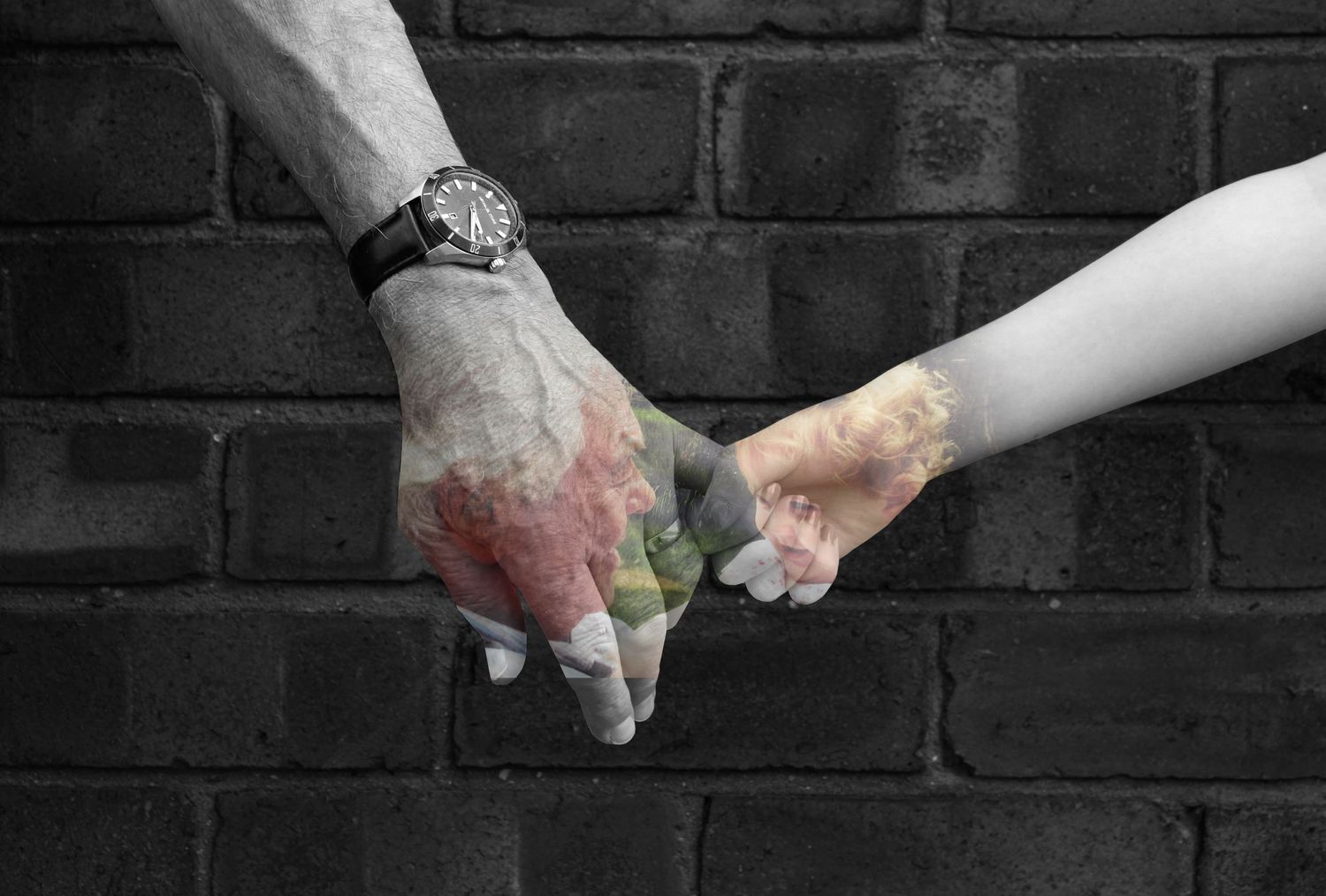 A grandparent and grandchild holding hands. Black and white. A photo of them both is overlayed.