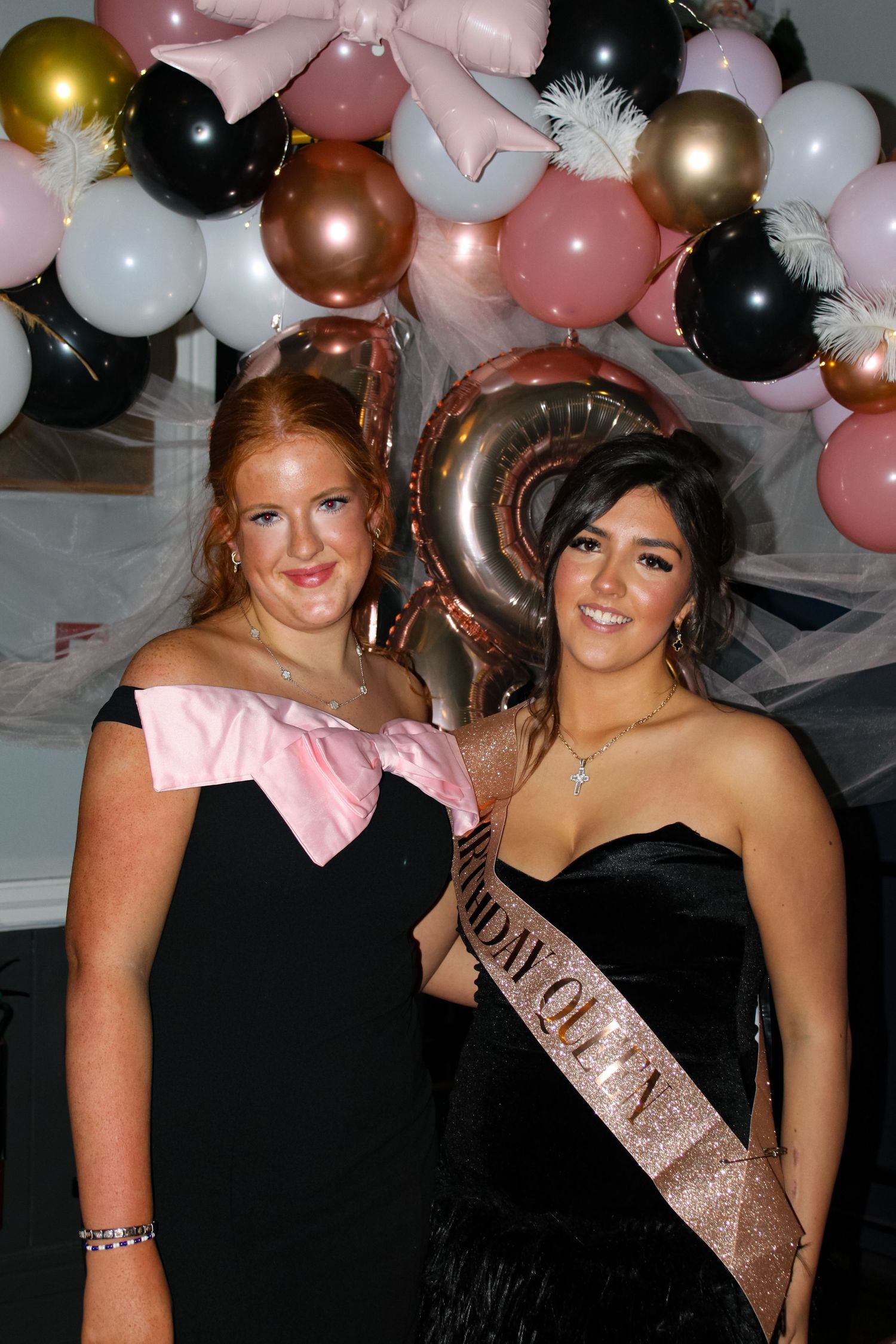 A portrait photo of two women hugging at an 18th Birthday party.