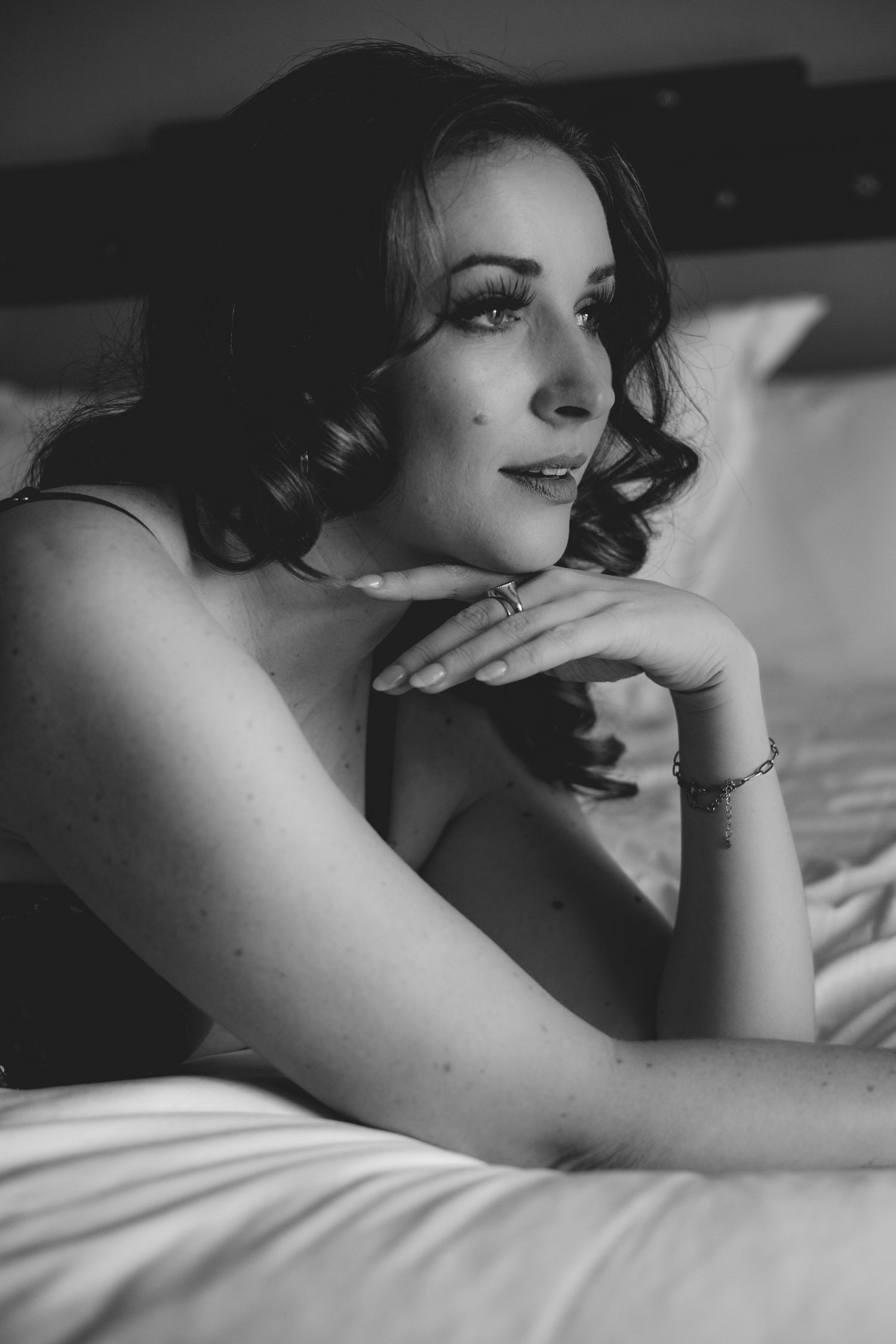 Intimate black and white boudoir portraits with soft lighting and shadows.