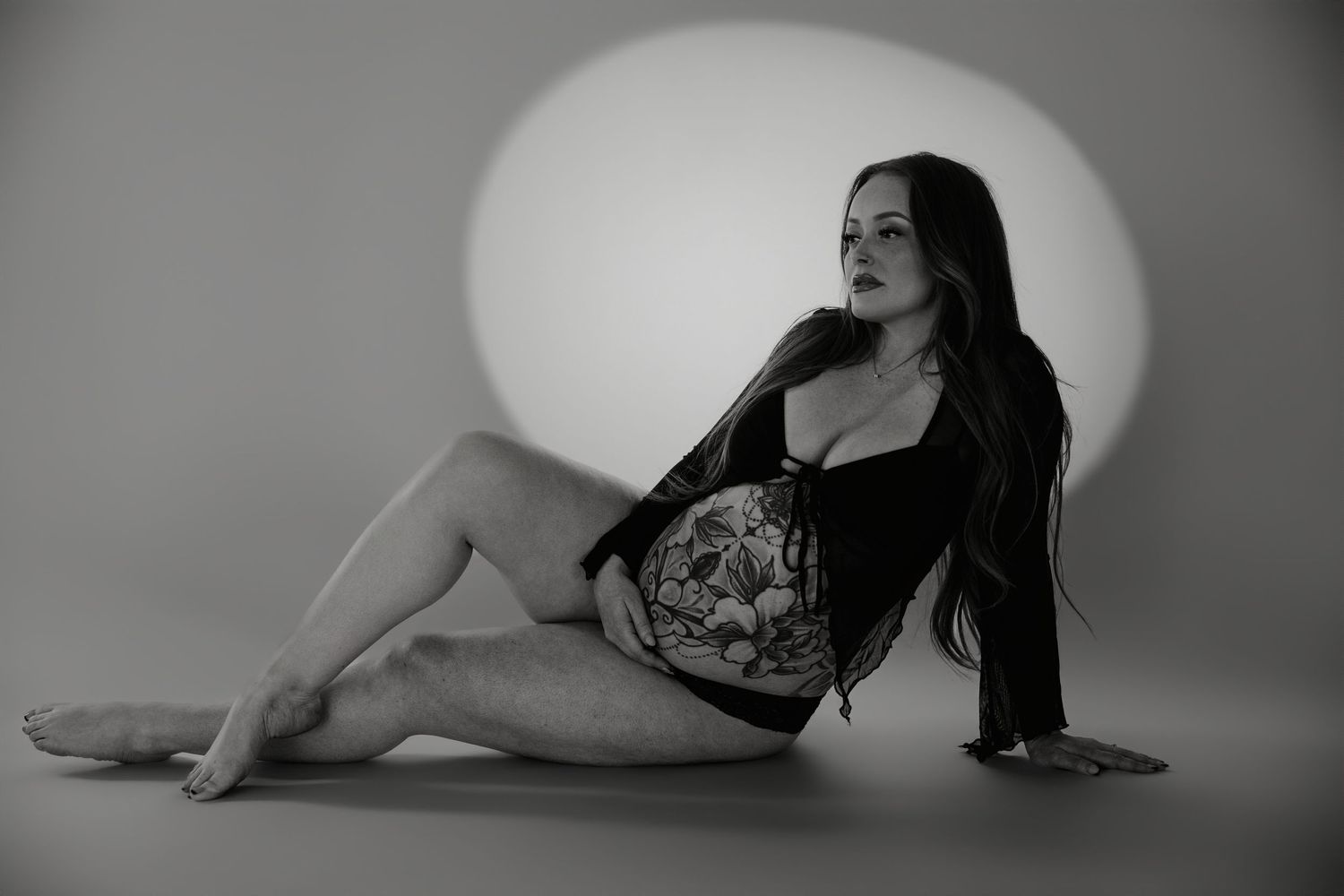 A series of black and white artistic boudoir photos showing a figure posing gracefully in lingerie against a light background.