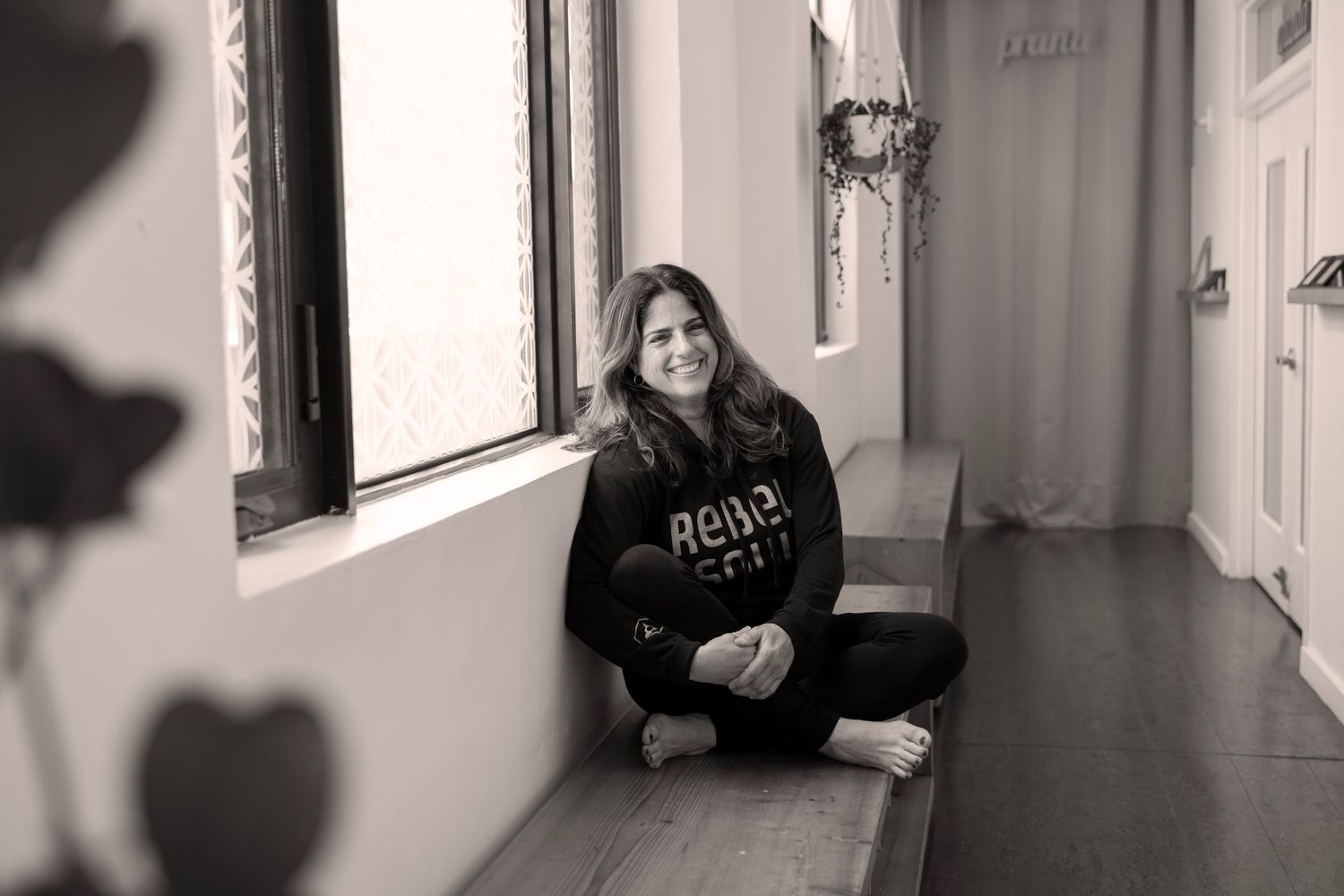 A black and white photo collage showing different interior views of a minimalist hallway with natural lighting.