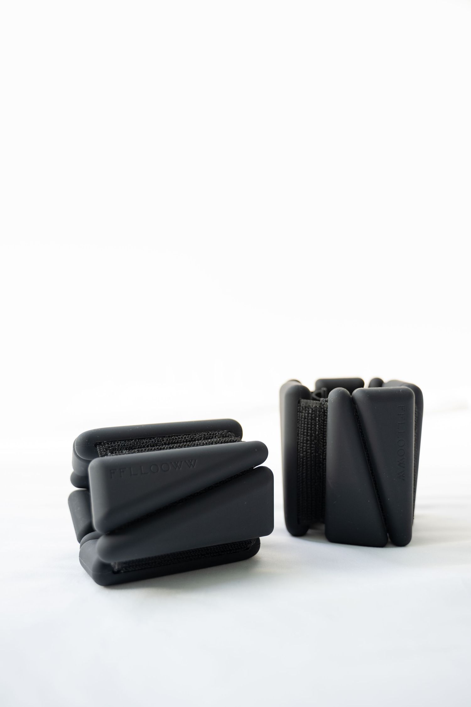 Sleek black geometric shapes arranged artistically on a white background.