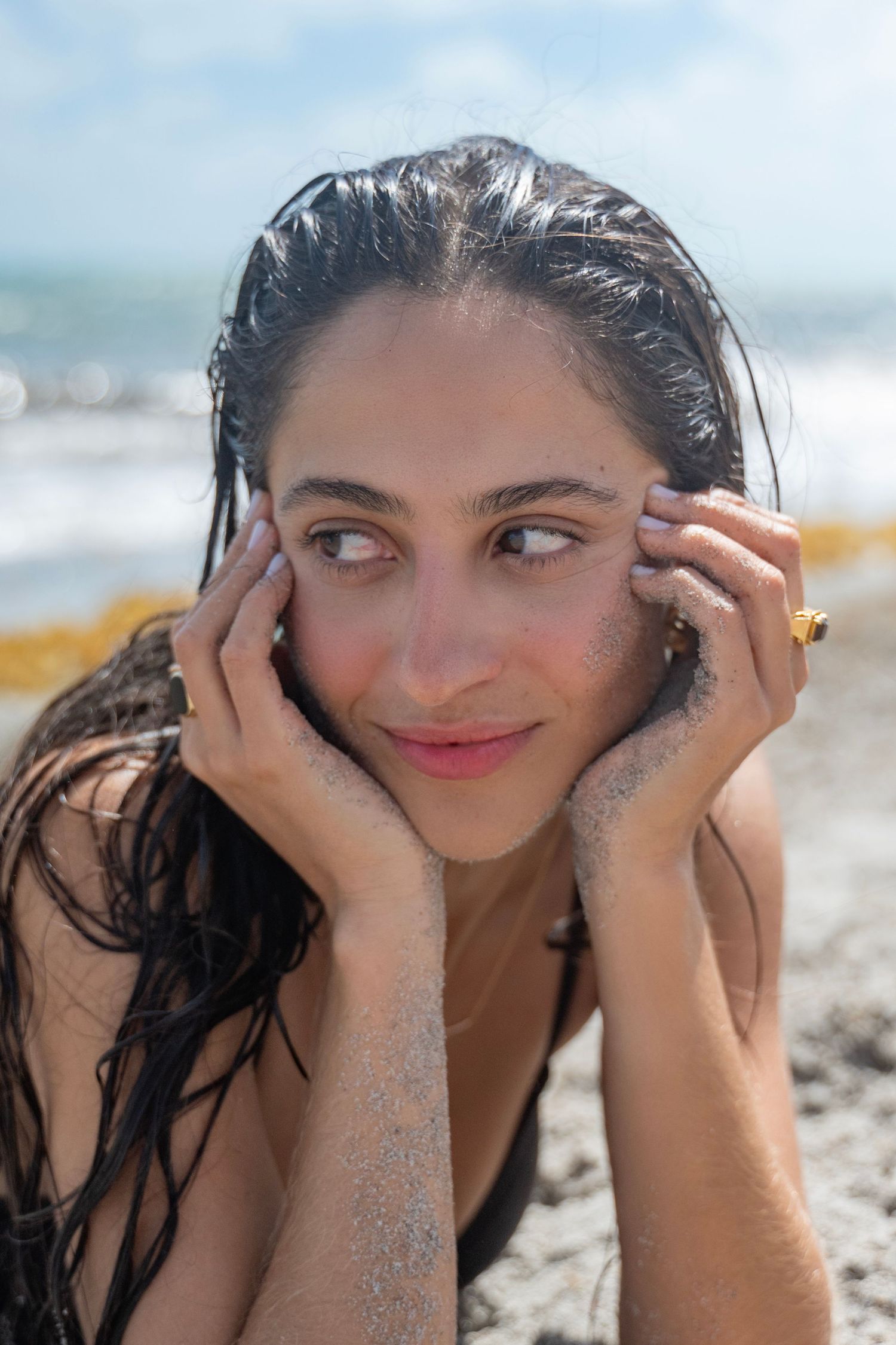 A sequence of photos shows a person with wet hair playing and posing expressively on a sunny beach.