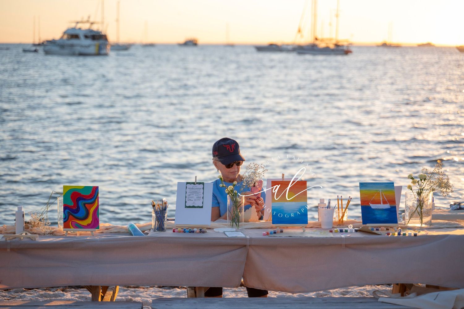 Colorful beach chairs and umbrellas line a sandy shoreline at sunset with calm waters in the background.