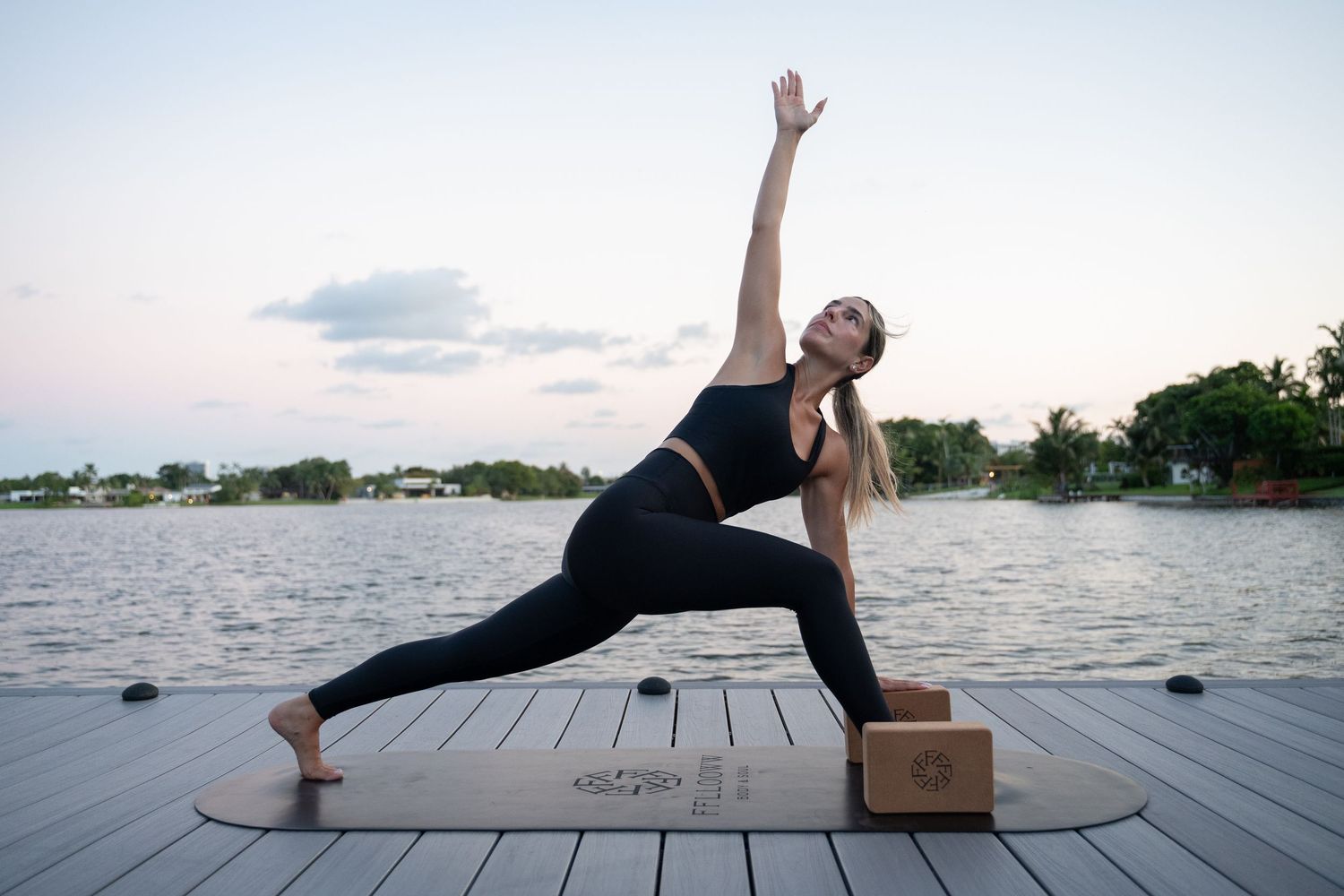 Yoga poses demonstrated on a wooden deck with water views.