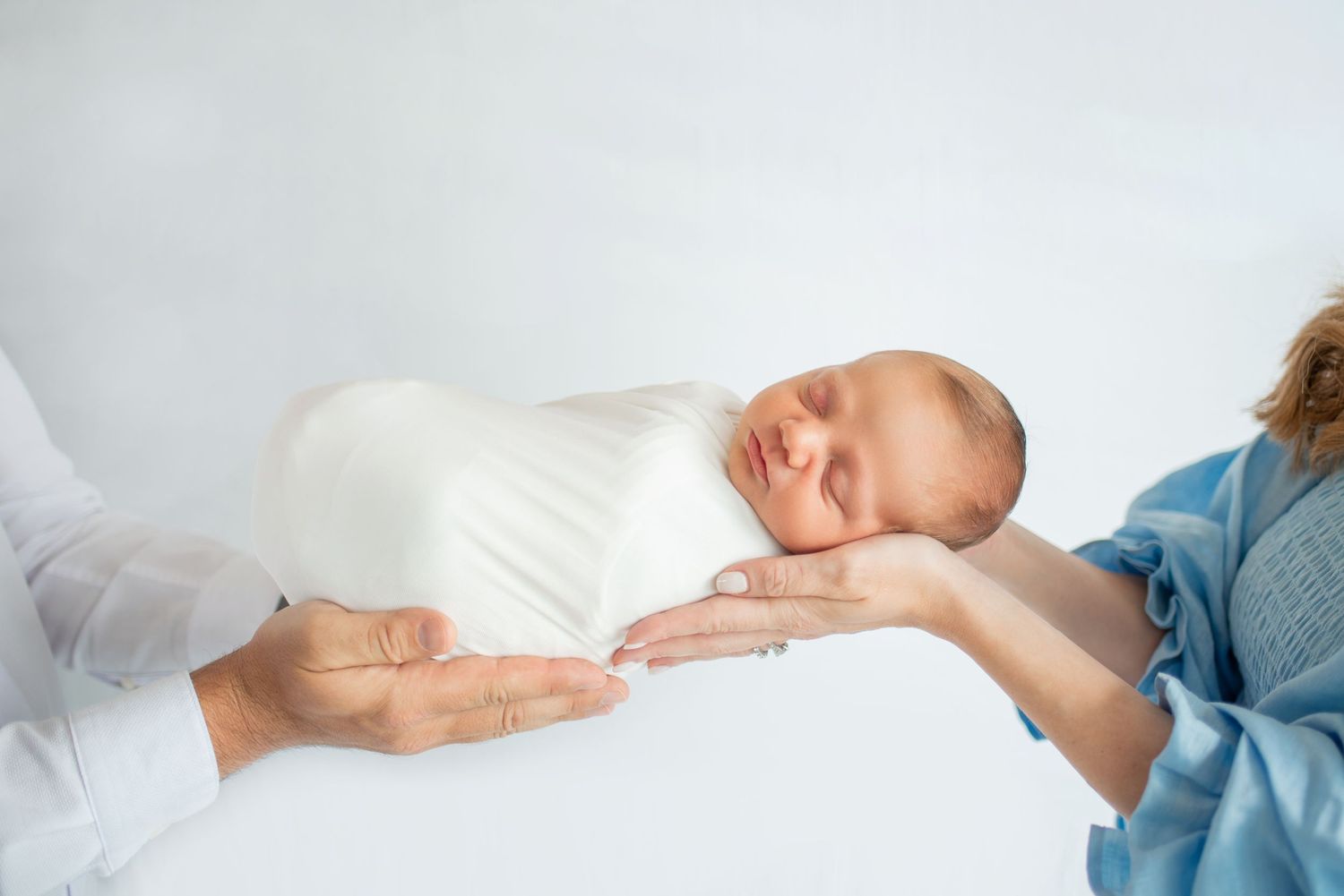 Family members sharing tender moments in a bright studio setting.
